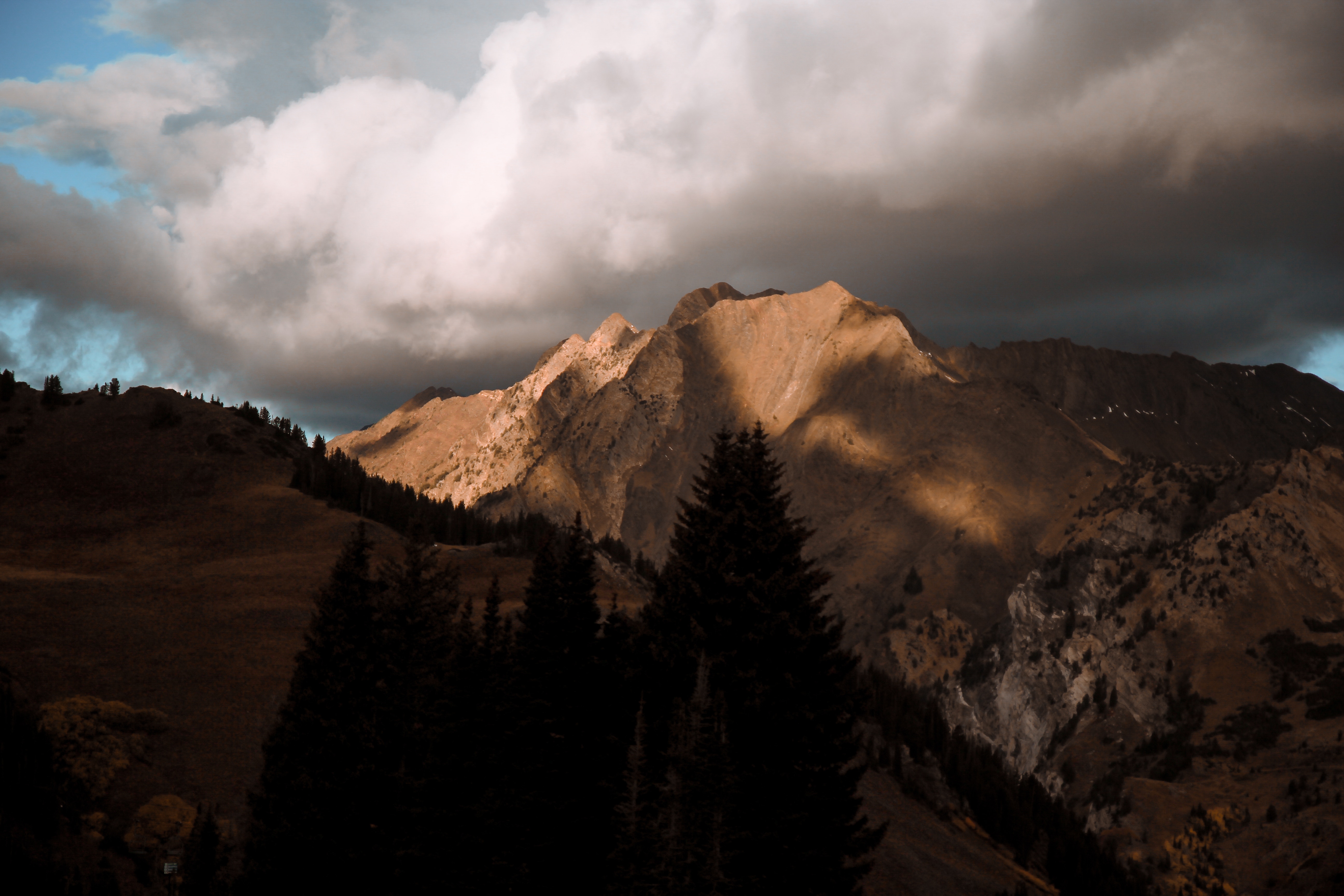 Mountain range with dramatic clouds at sunset HD Wallpaper
