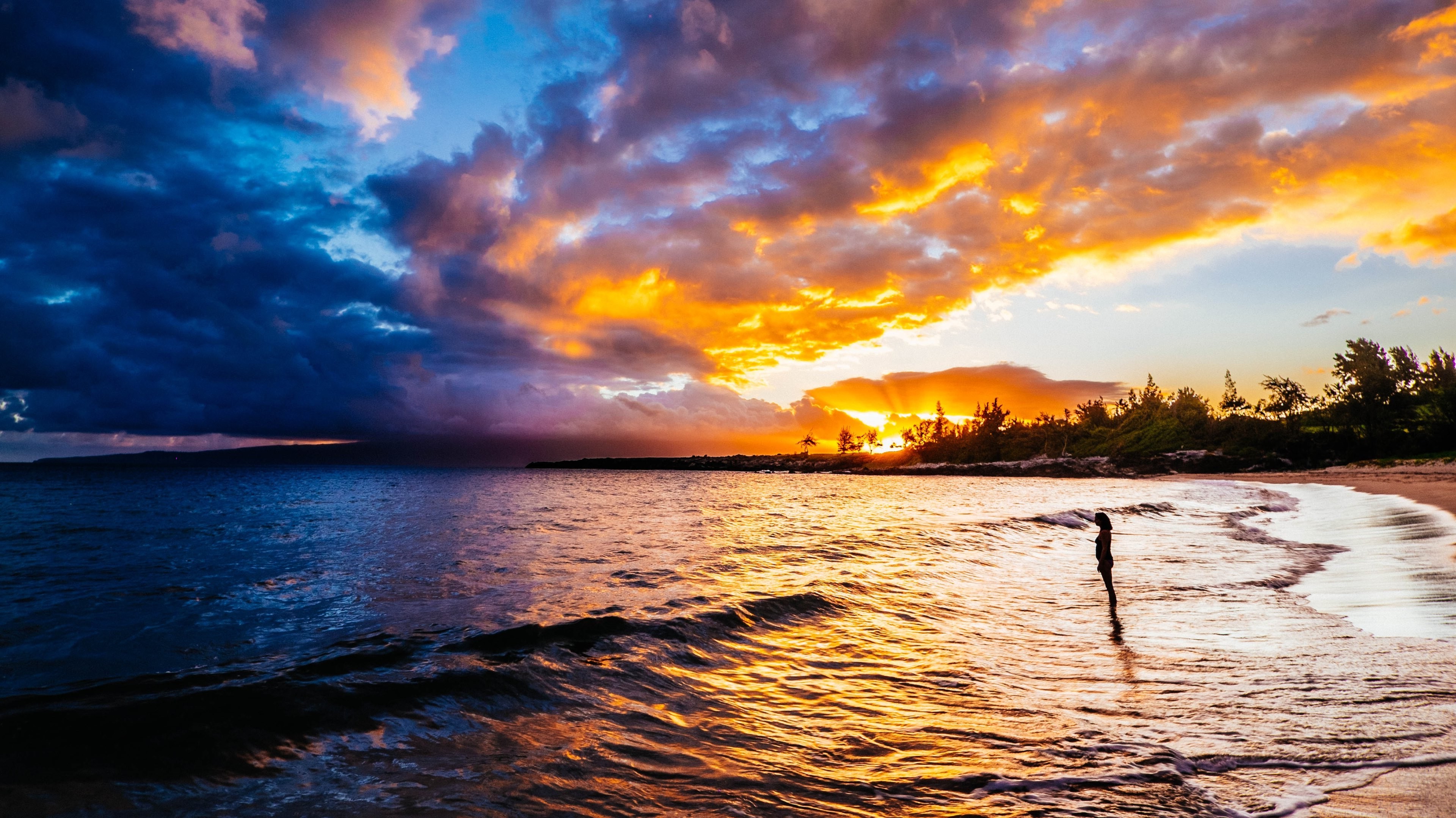 Sunset over the ocean with a person on the beach HD Wallpaper