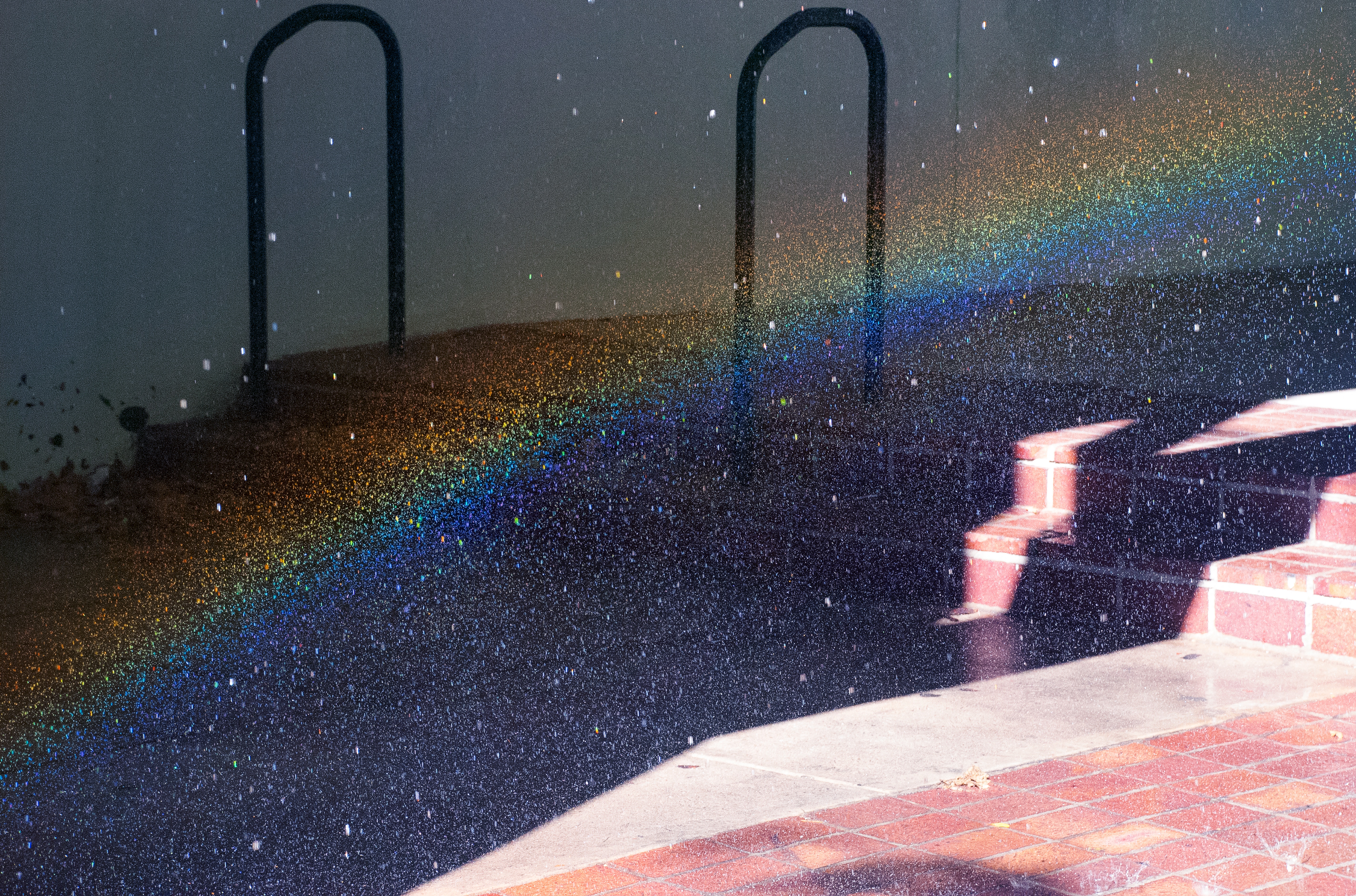 Rainbow light art from sprinkler on stairs HD Wallpaper