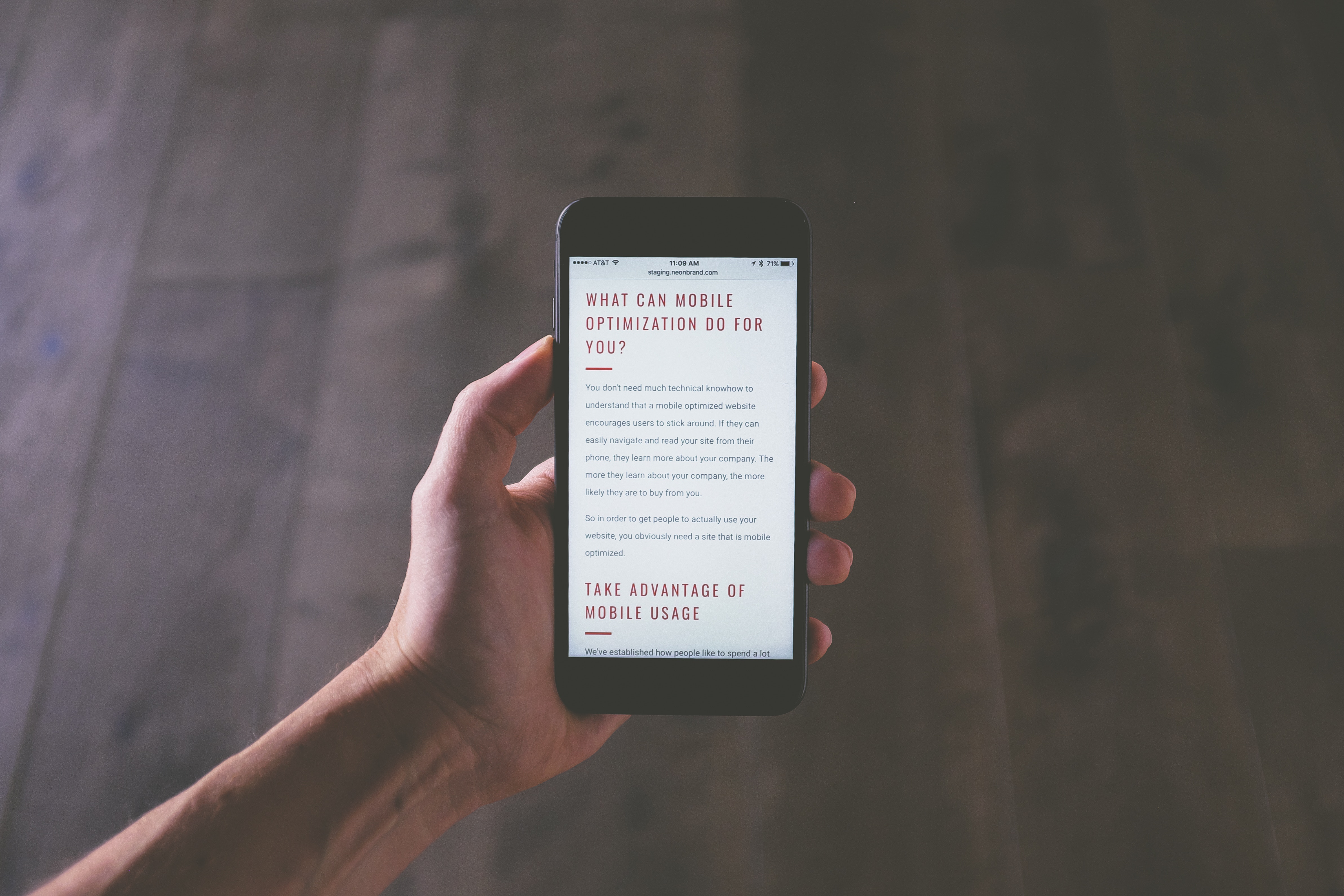 Hand holding iPhone displaying mobile optimization website HD Wallpaper