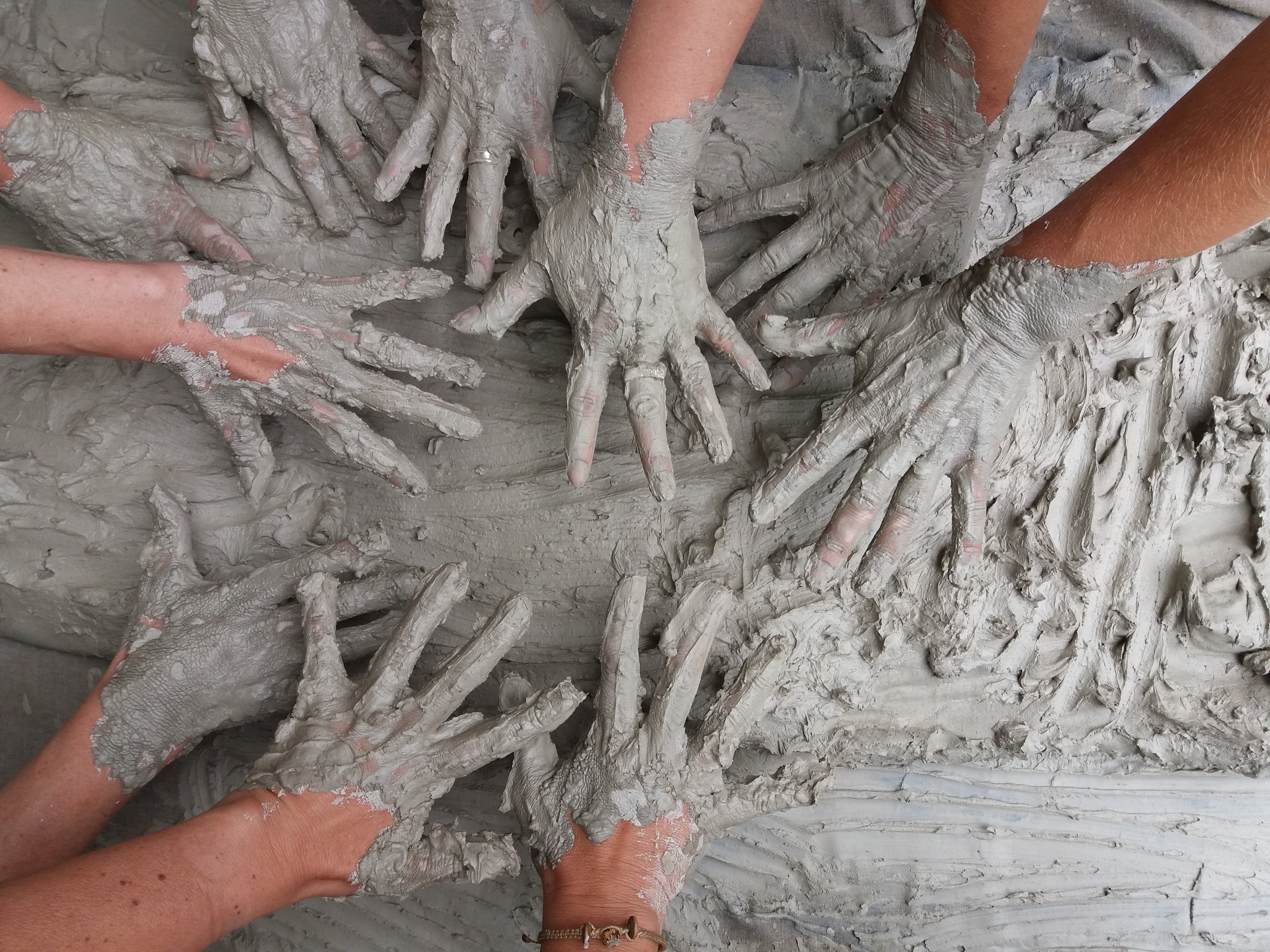 Hands covered in mud playing together HD Wallpaper