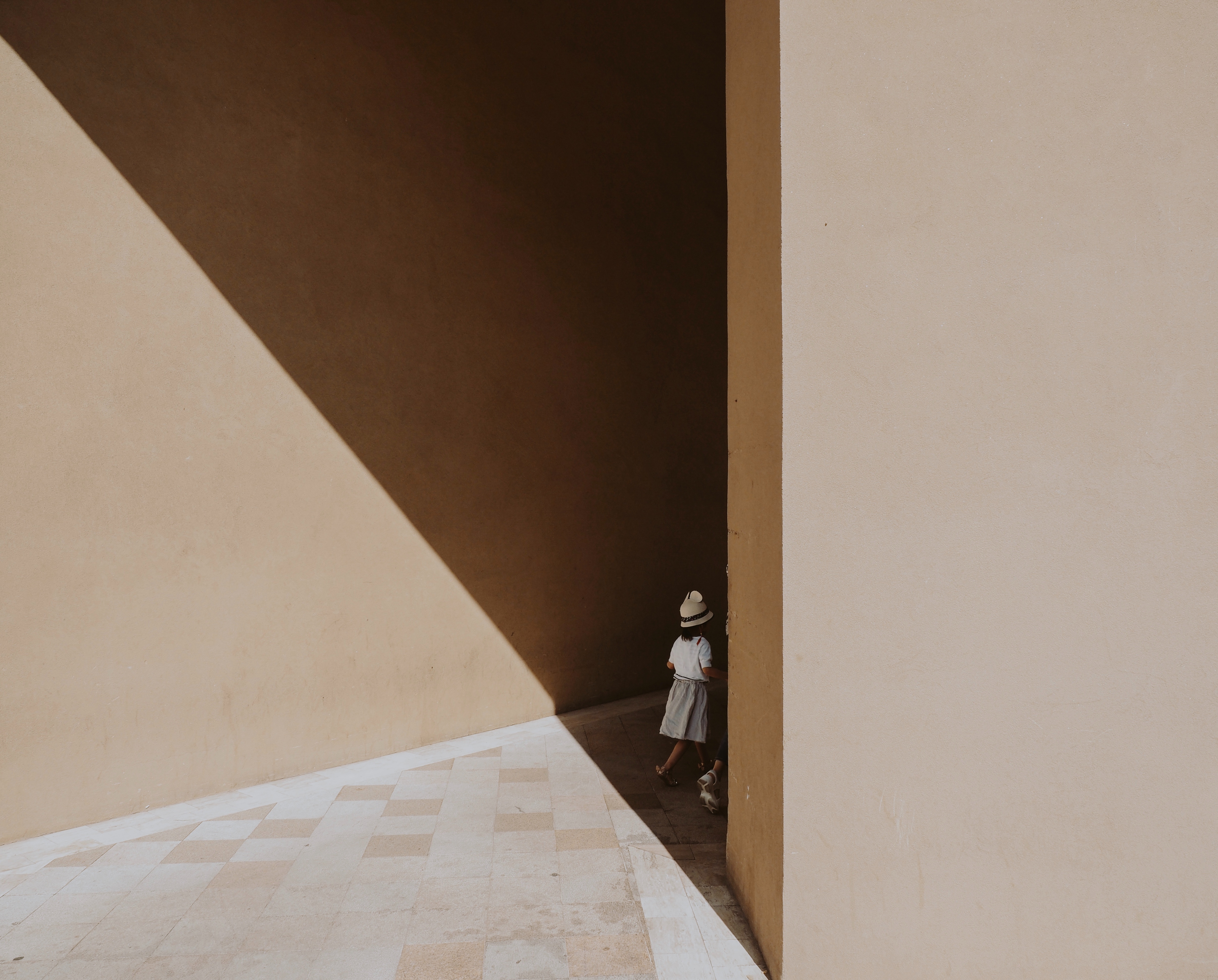 Girl walking in geometric shadows HD Wallpaper