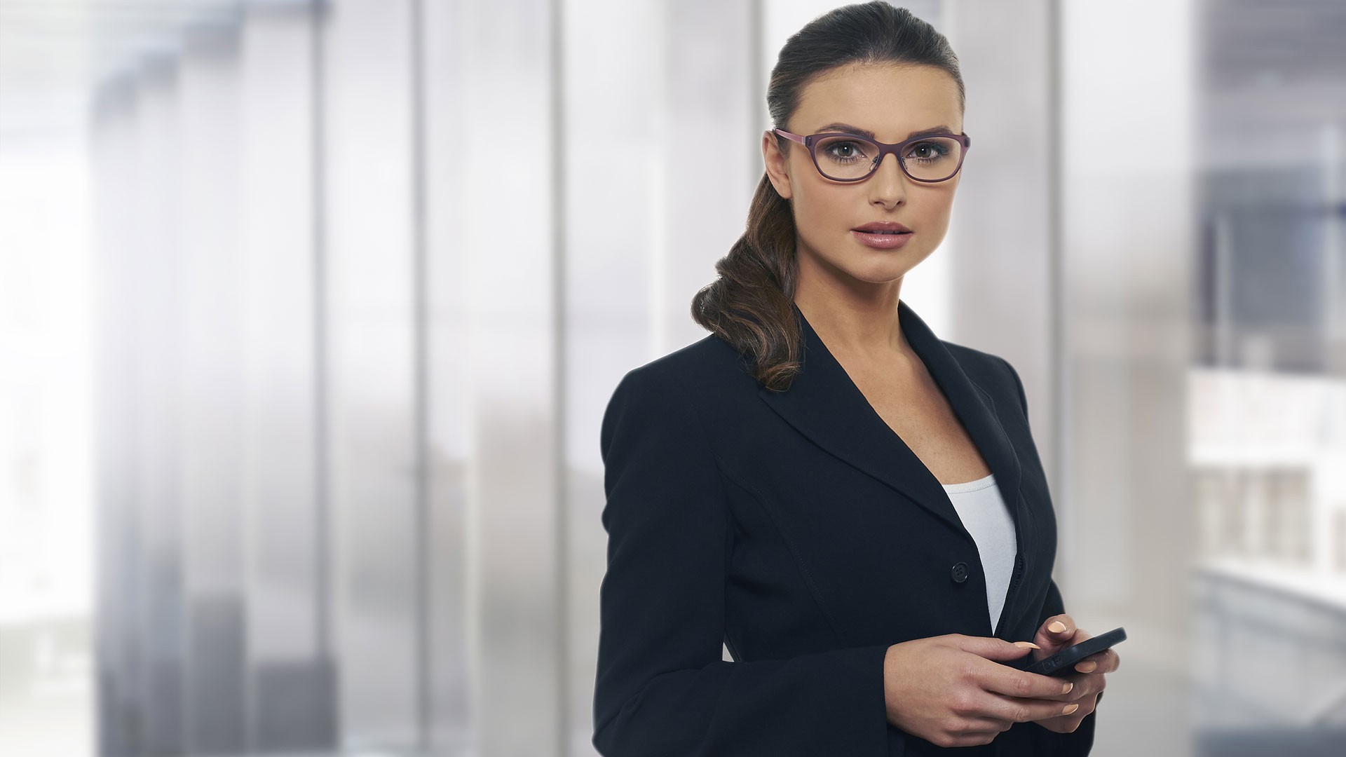 Woman in suit and glasses holding a phone HD Wallpaper