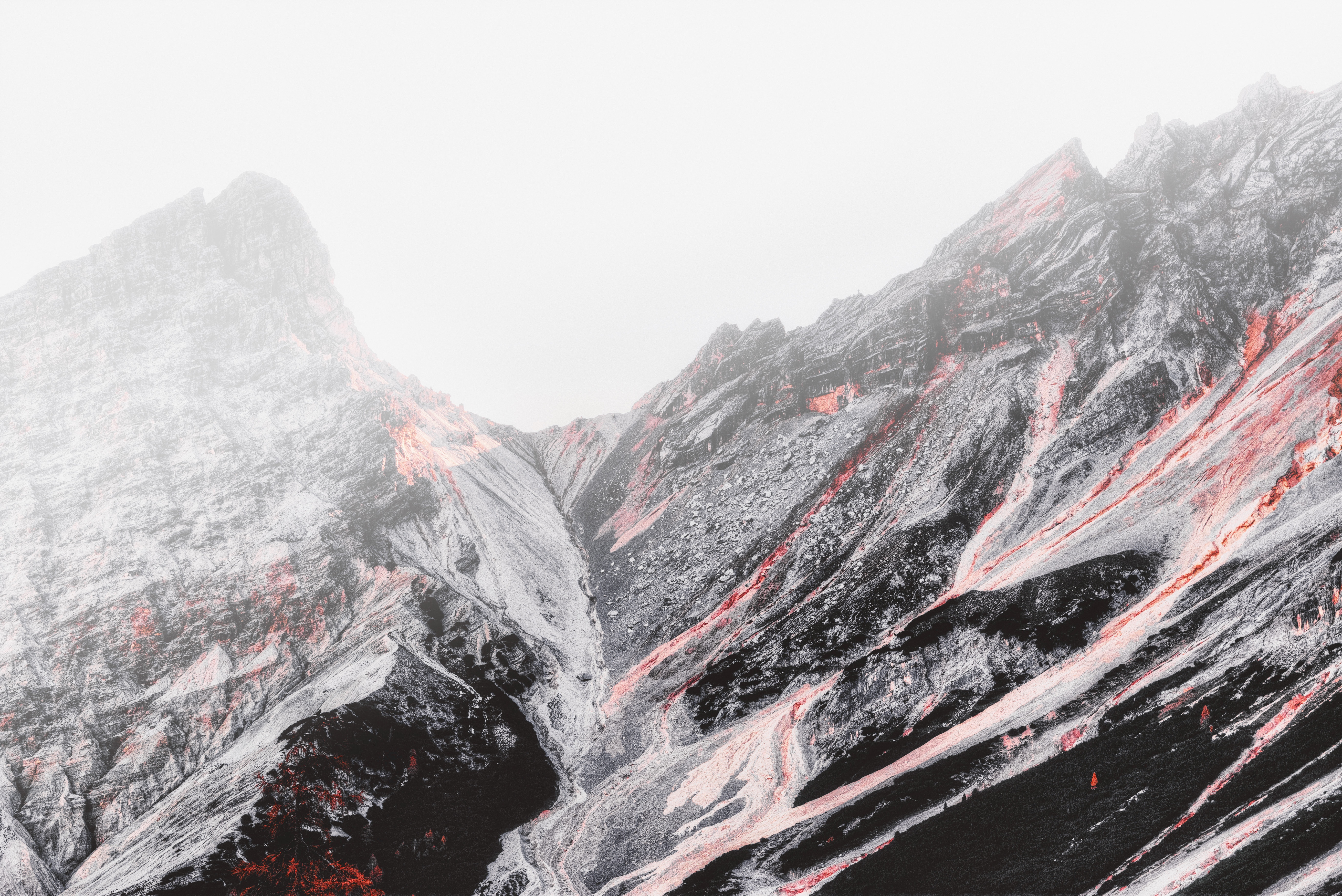 Volcanic mountain range with red streaks under fog HD Wallpaper