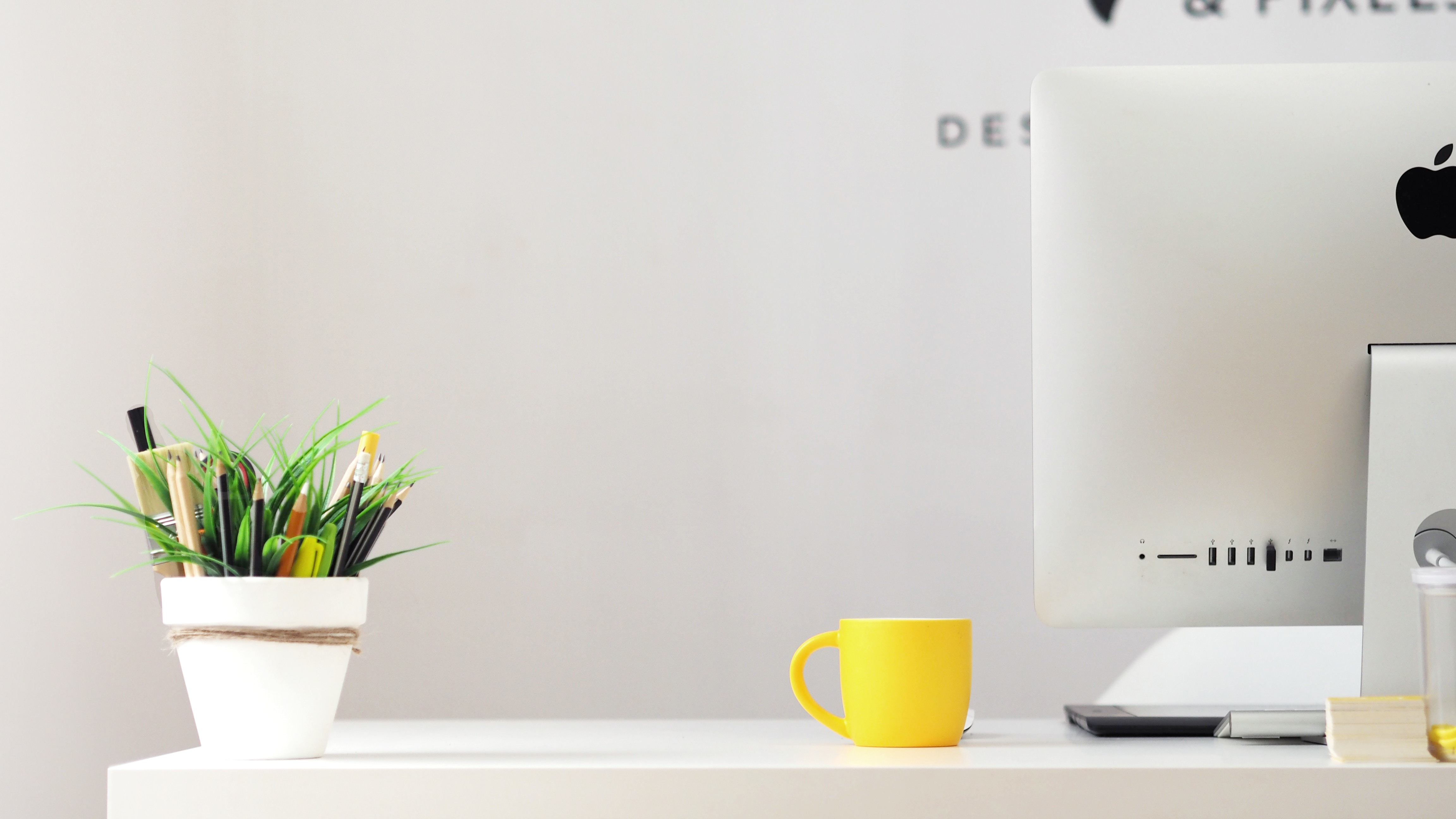 Yellow mug and iMac on a white desk HD Wallpaper