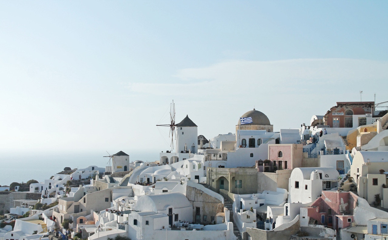 Whitewashed village with windmills in Santorini, Greece HD Wallpaper