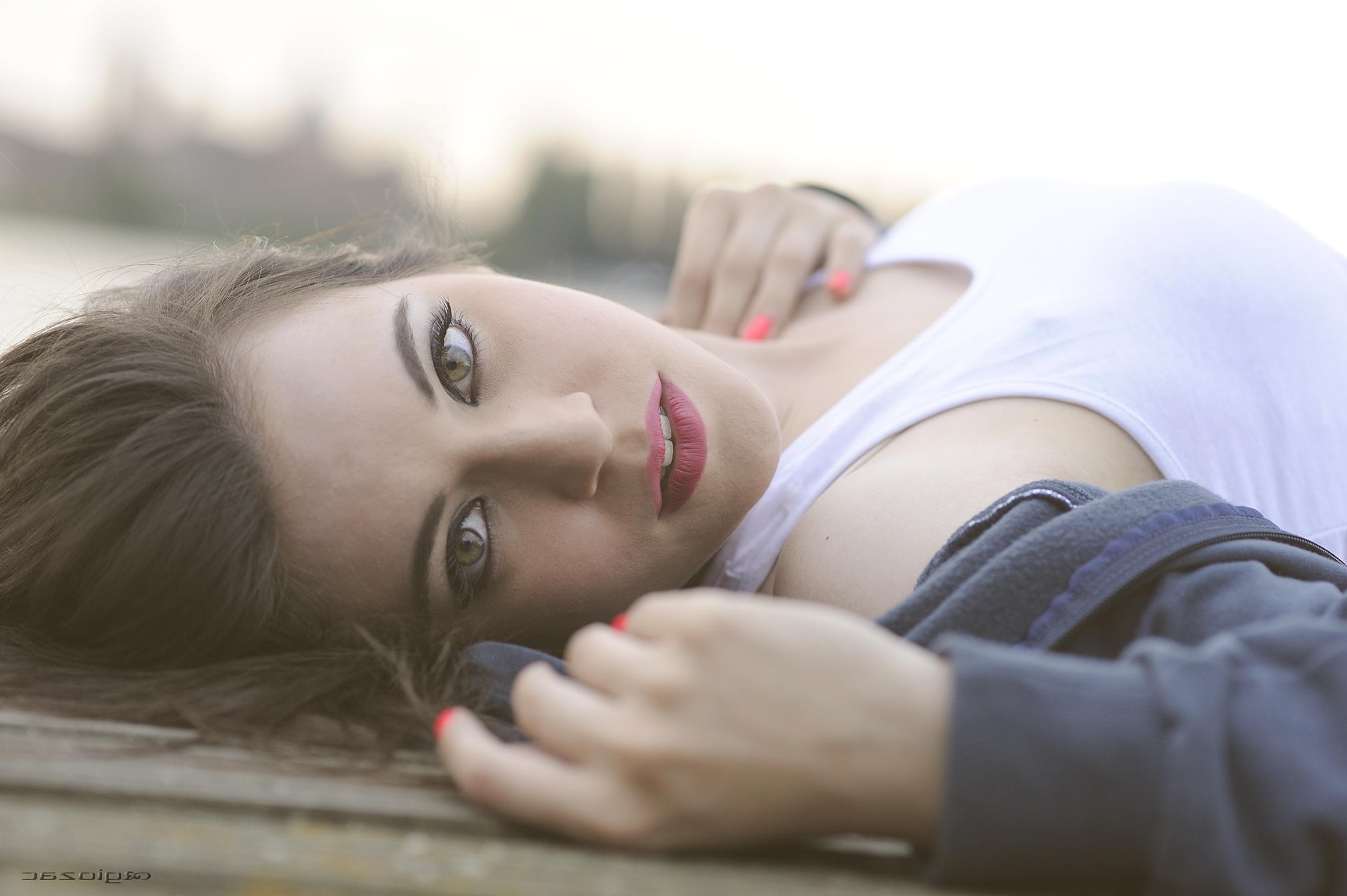 Woman with long brown hair lying down HD Wallpaper