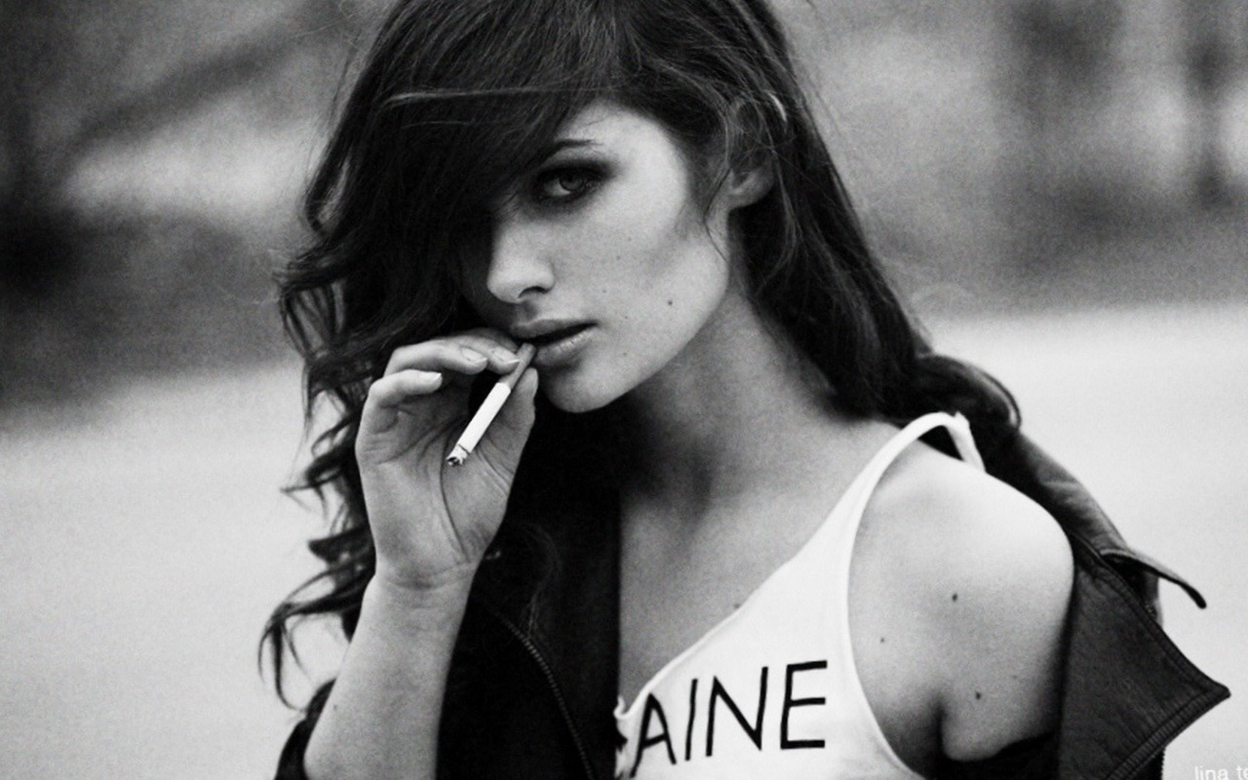 Woman smoking cigarette with hair in face HD Wallpaper