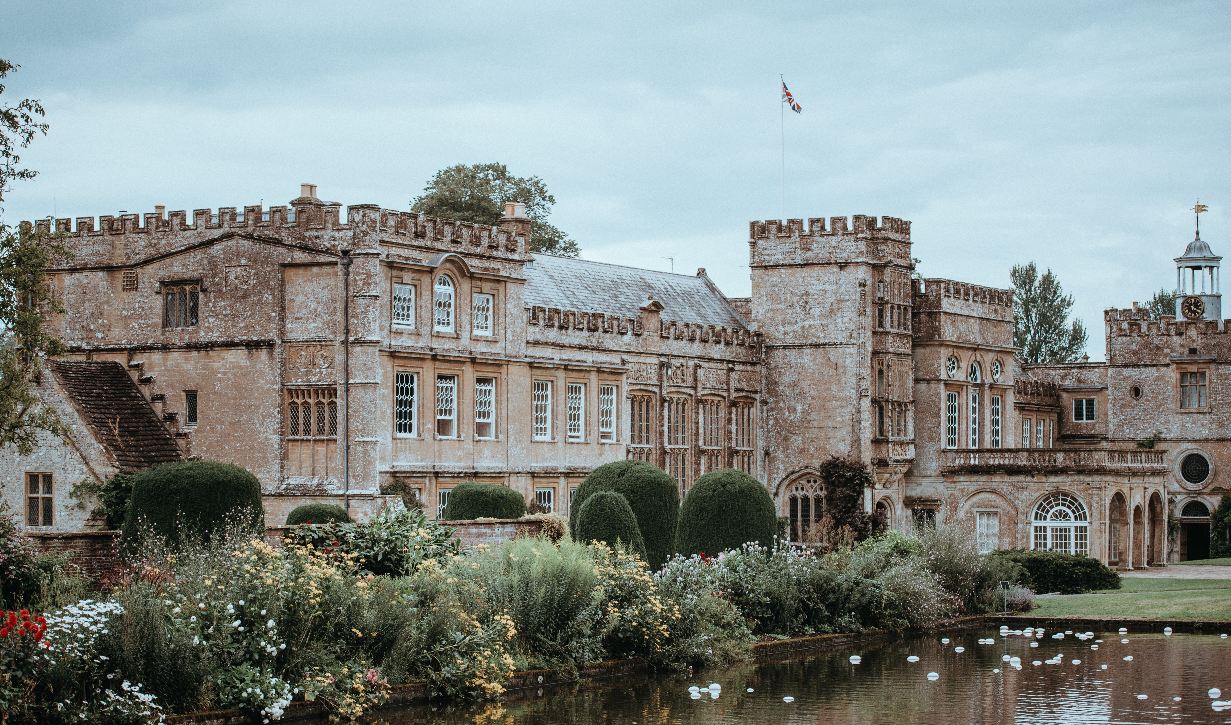 Stone mansion with a lake and garden HD Wallpaper
