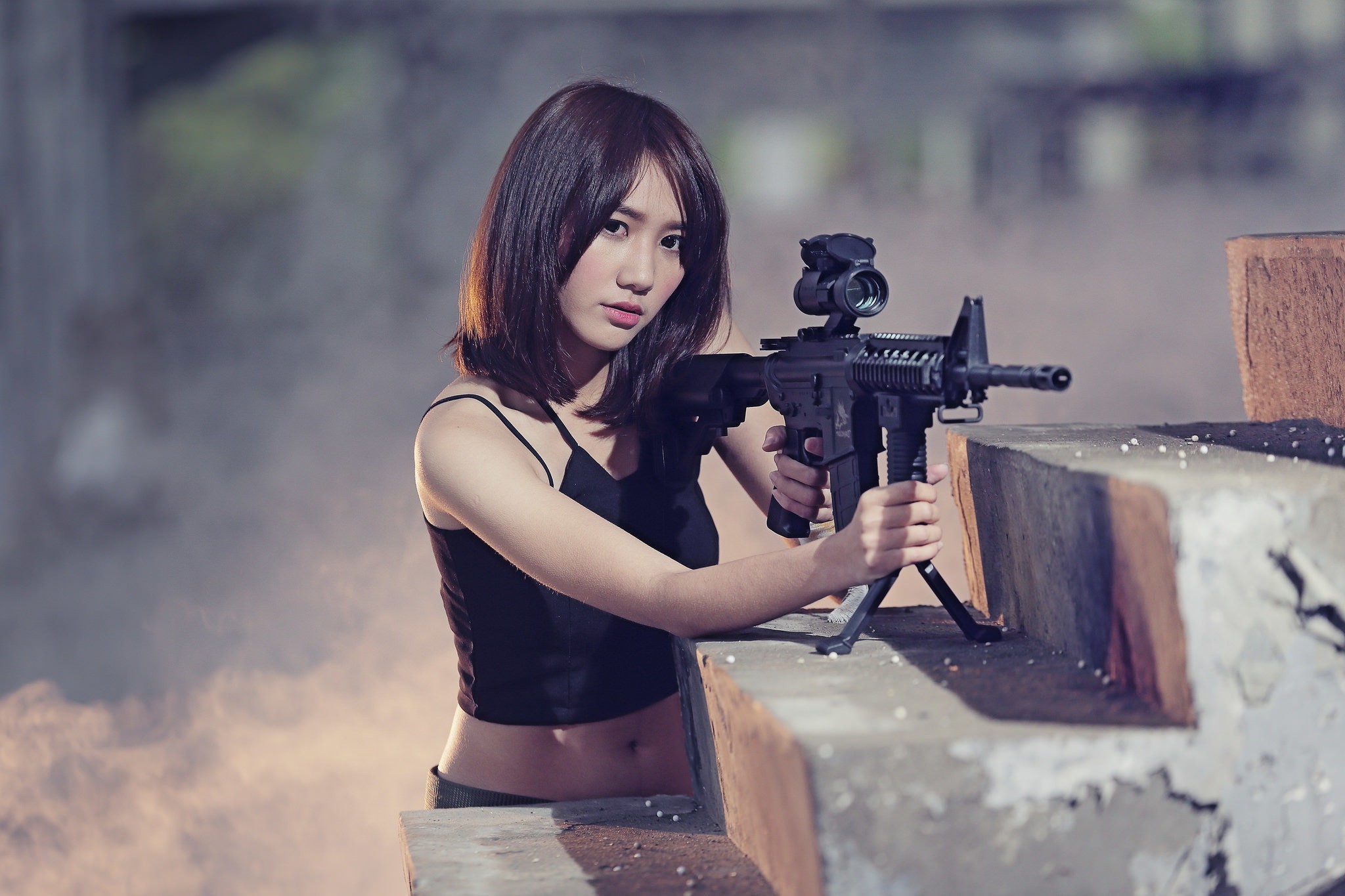 Asian woman holding a rifle HD Wallpaper