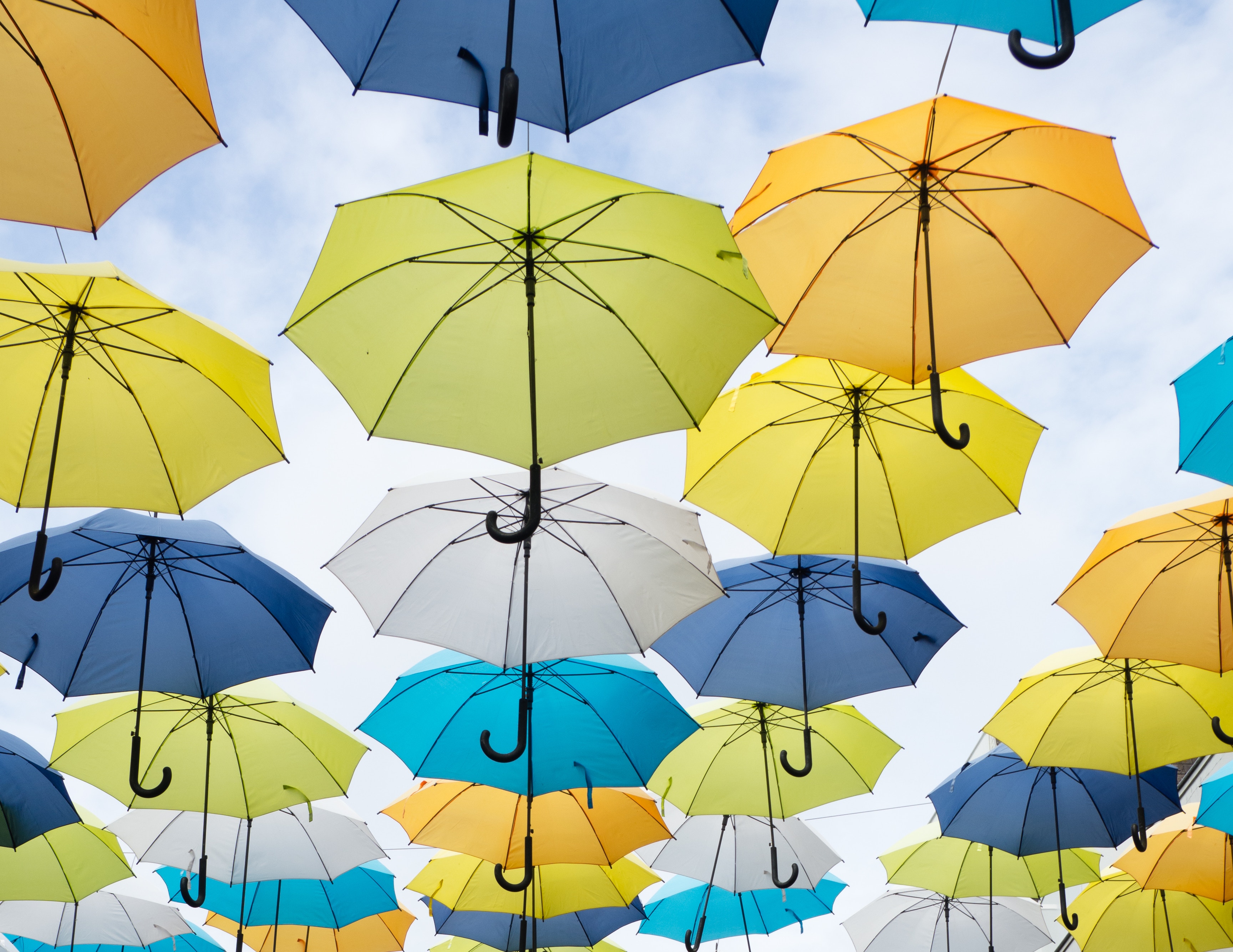 Colorful umbrellas suspended in the sky HD Wallpaper