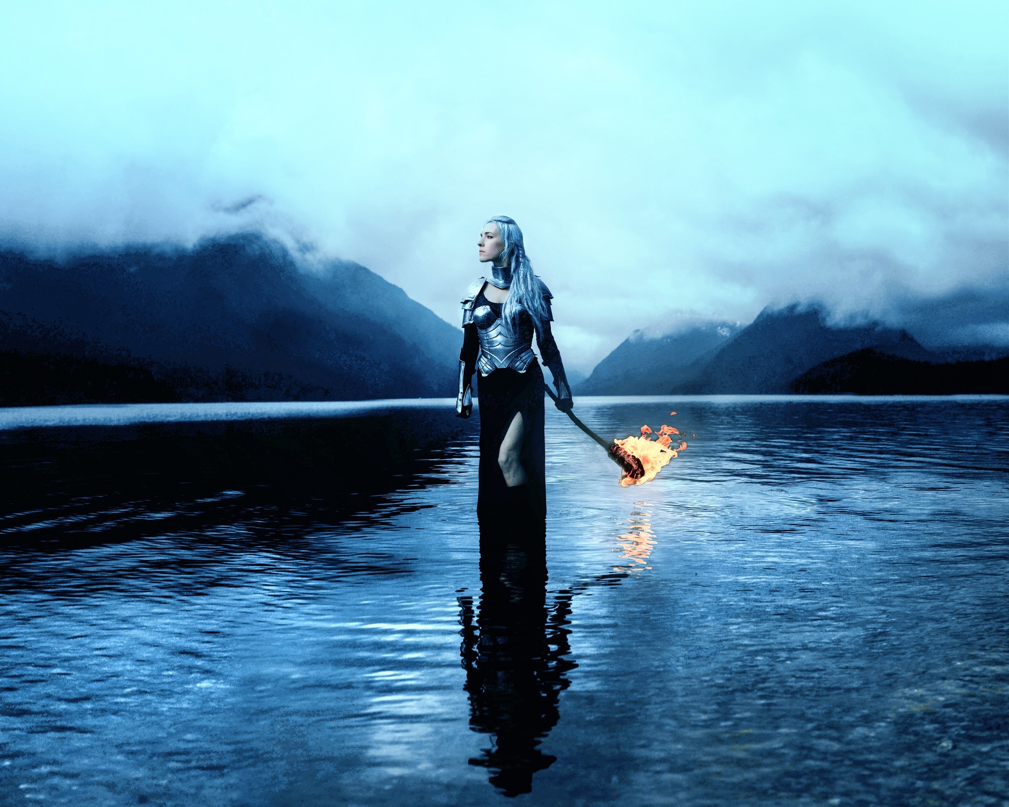 Woman with flaming torch in a lake HD Wallpaper