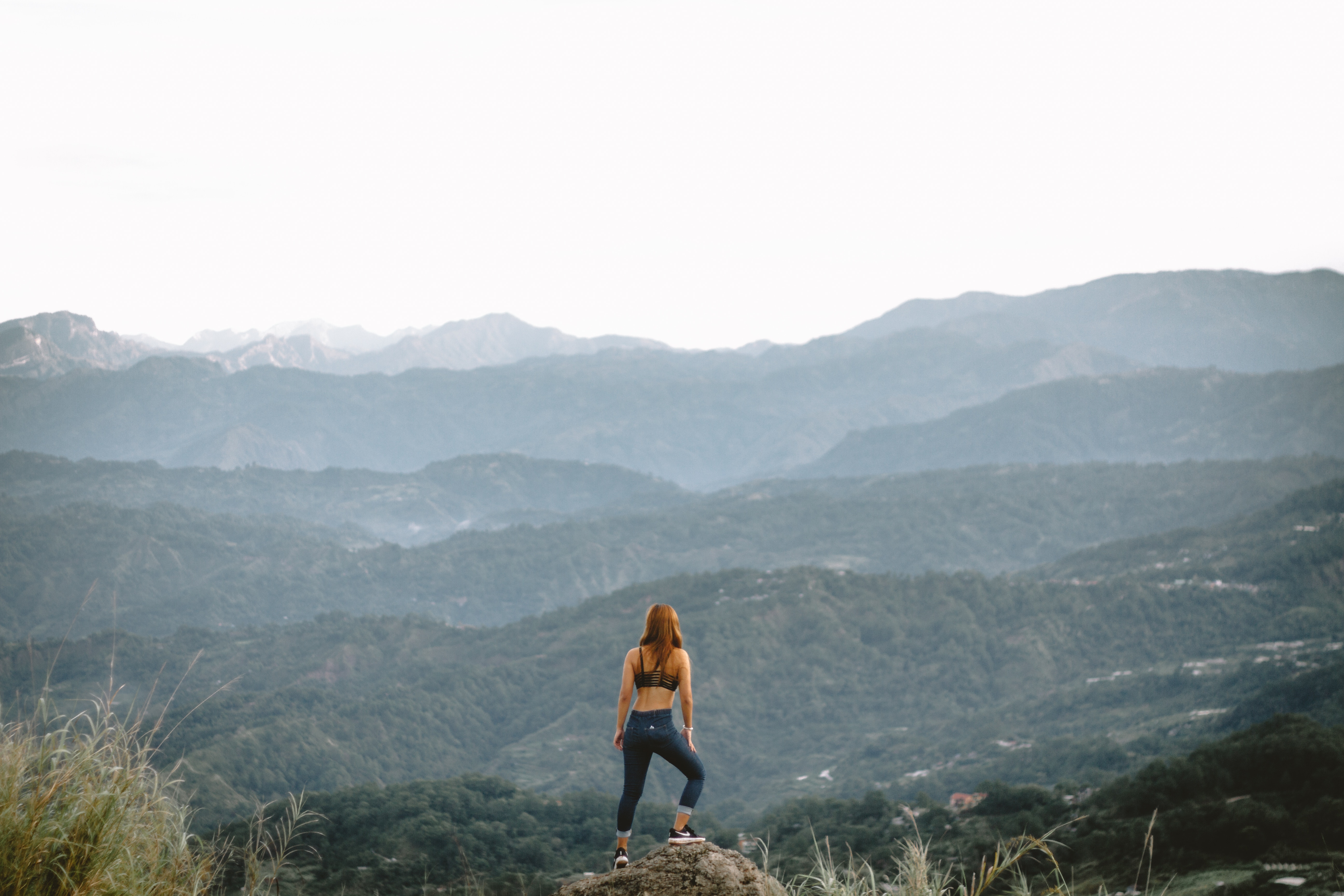 Woman on rock overlooking mountains in Baguio HD Wallpaper