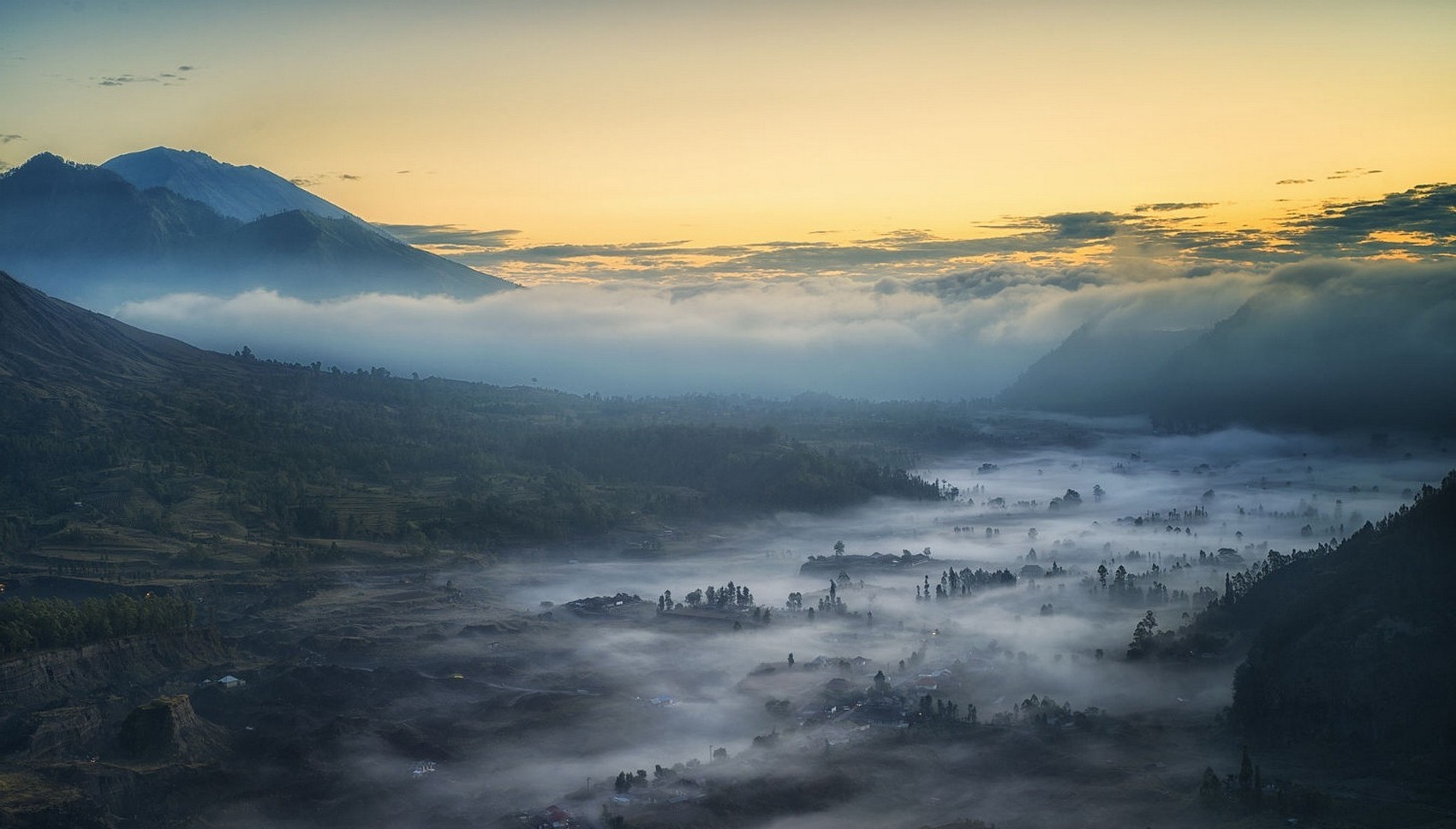 Misty valley with mountains at sunrise HD Wallpaper