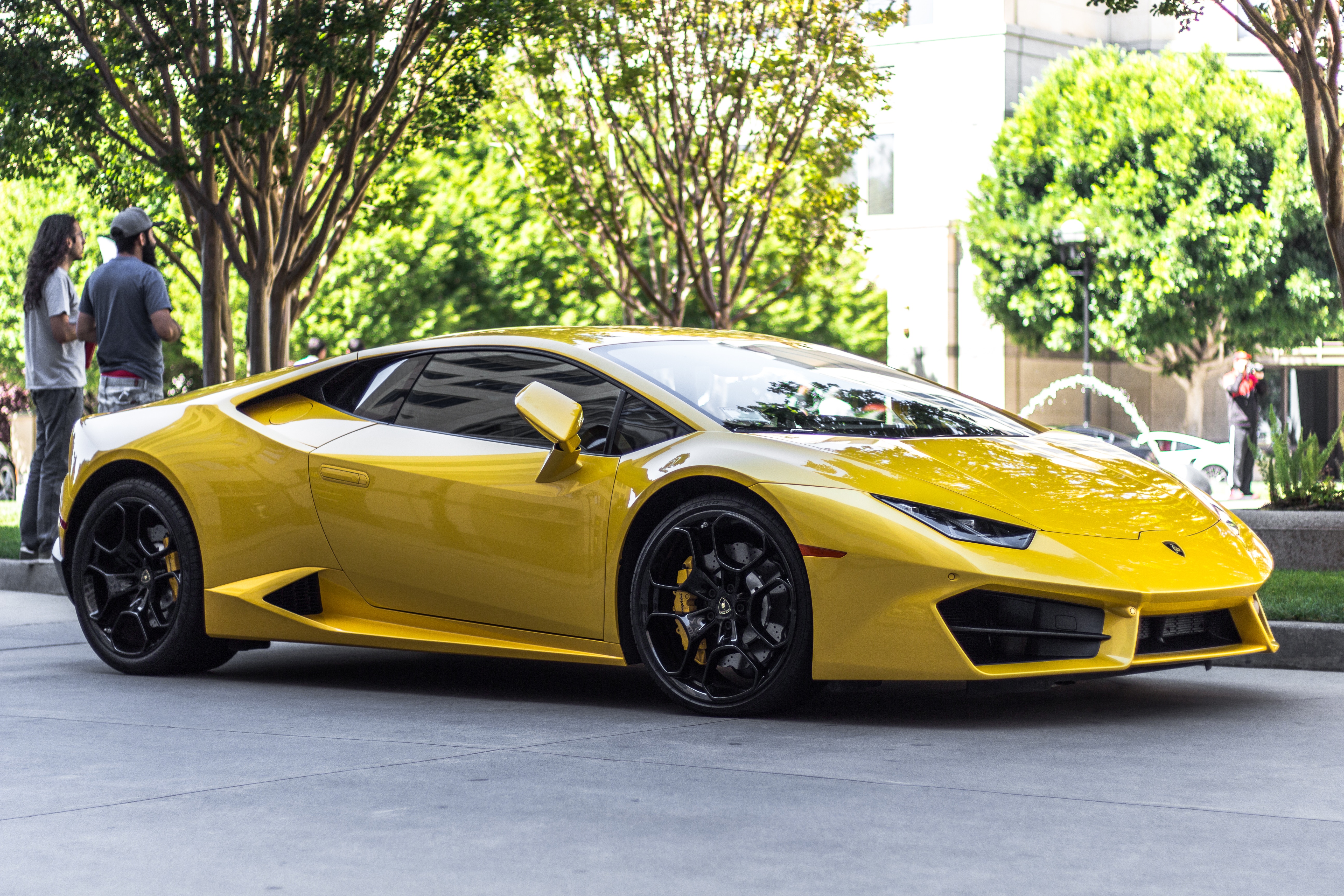 Yellow Lamborghini Huracan parked on a street HD Wallpaper