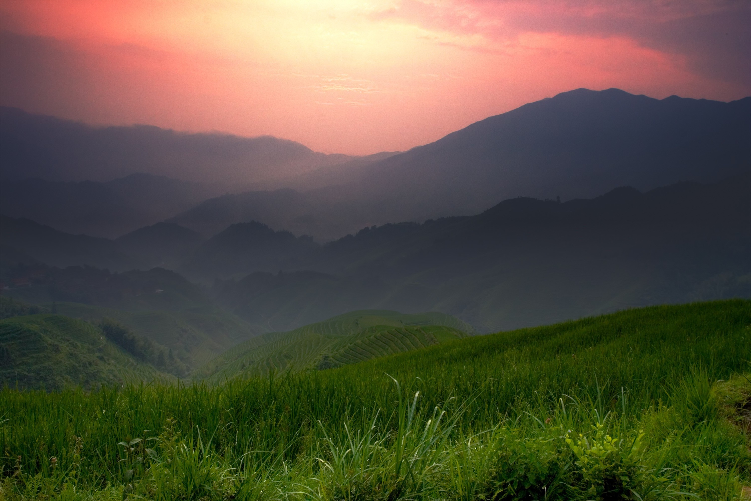Sunset Over Rolling Green Hills and Misty Mountains HD Wallpaper