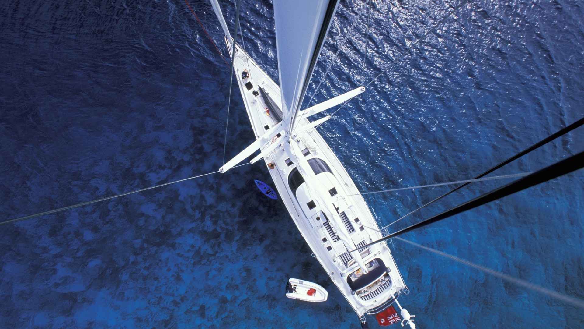 Sailing yacht from above in blue water HD Wallpaper