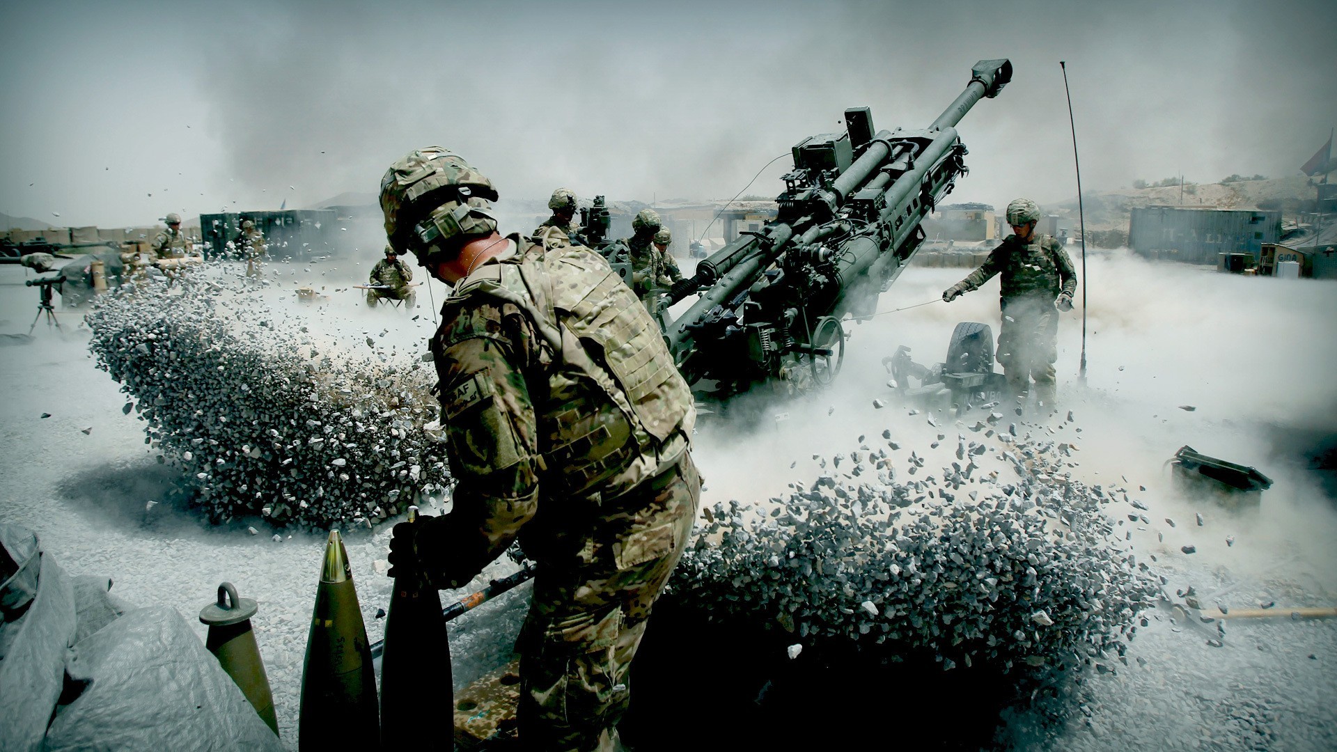 Soldiers firing artillery howitzer HD Wallpaper