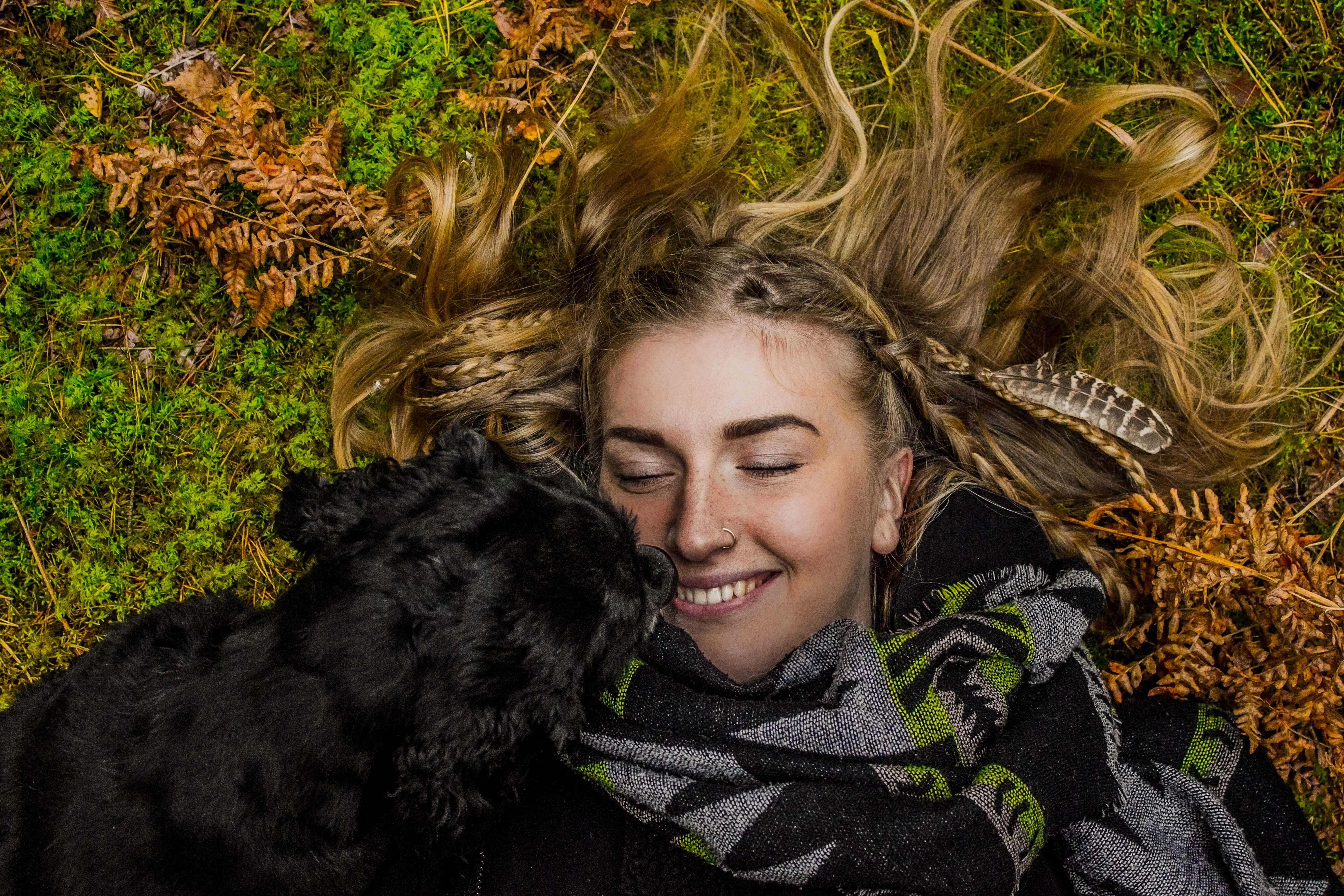 Woman and dog lying in autumn nature HD Wallpaper