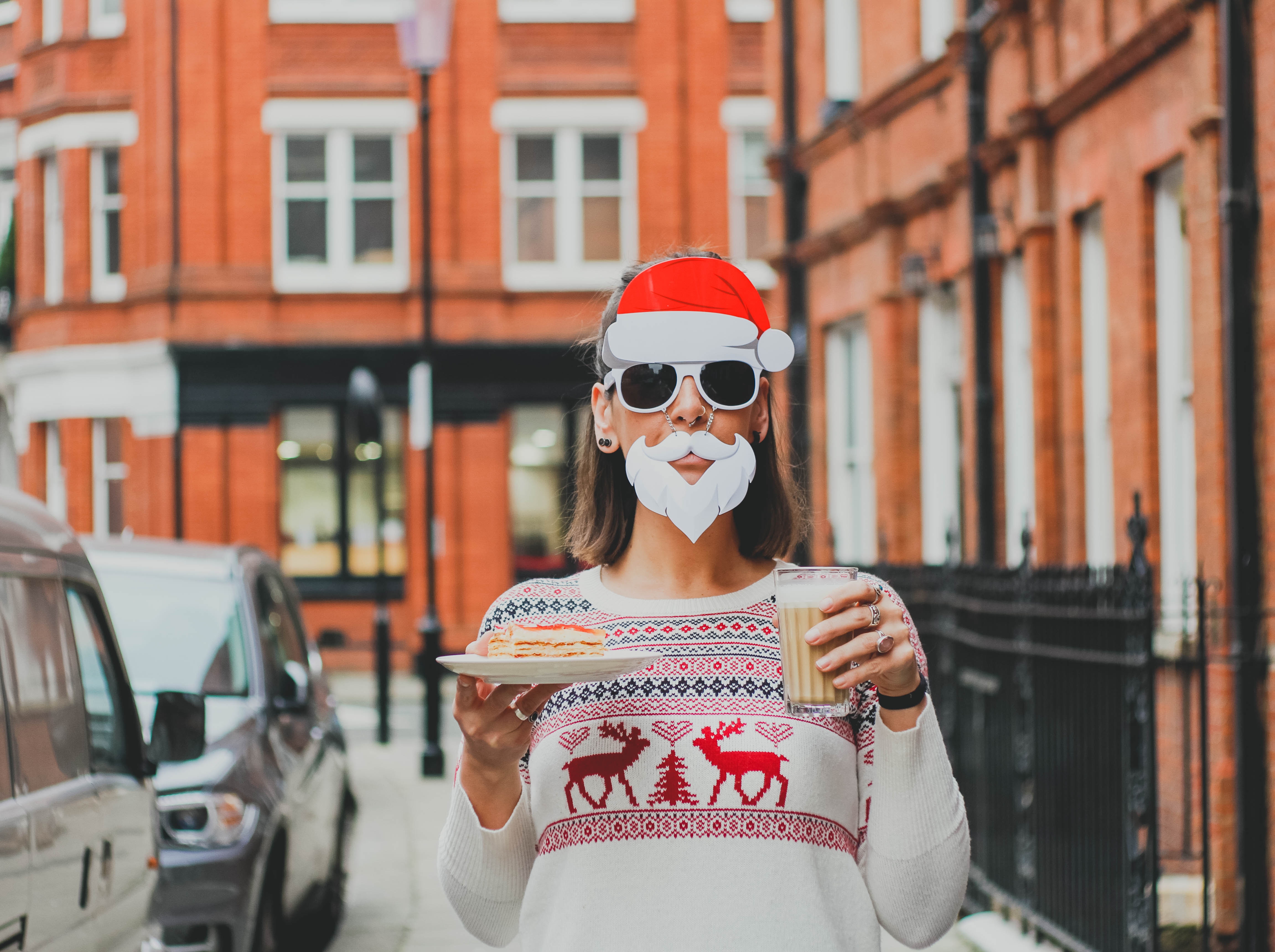 Woman in Santa costume holding a drink and cake HD Wallpaper