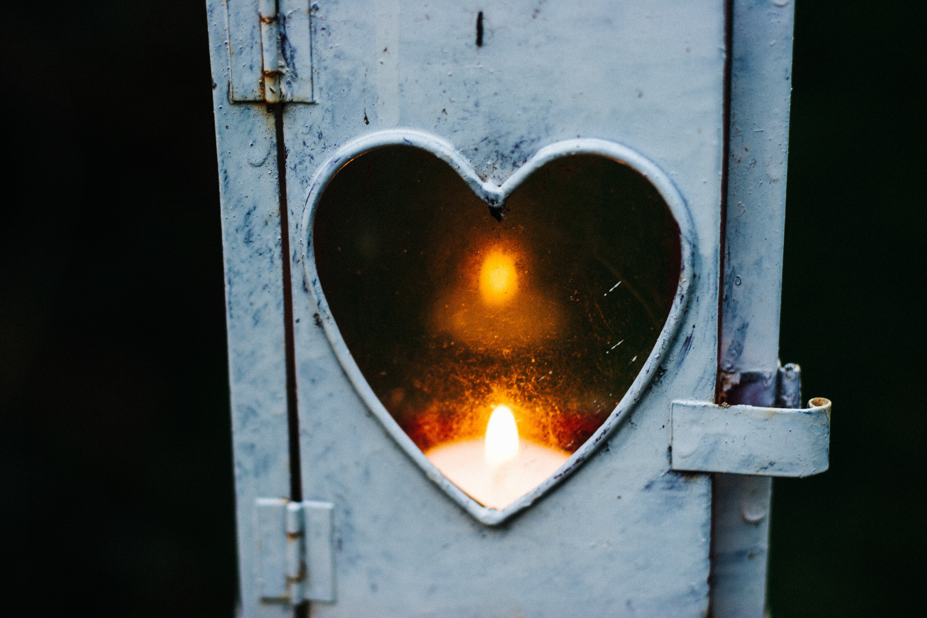 Candle burning inside a heart-shaped lantern HD Wallpaper