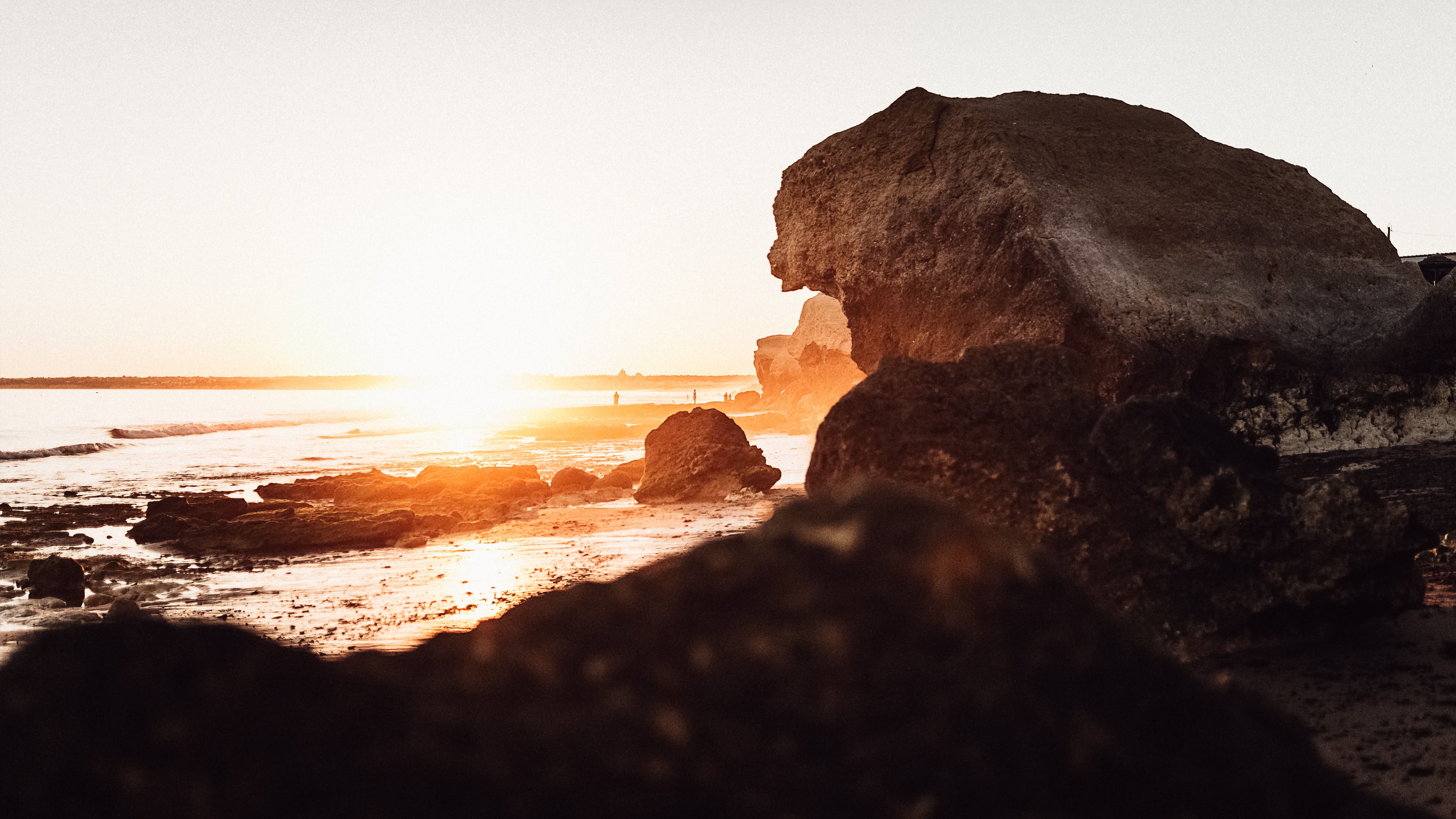 Sunset over the rocky shore of Albufeira, Portugal HD Wallpaper