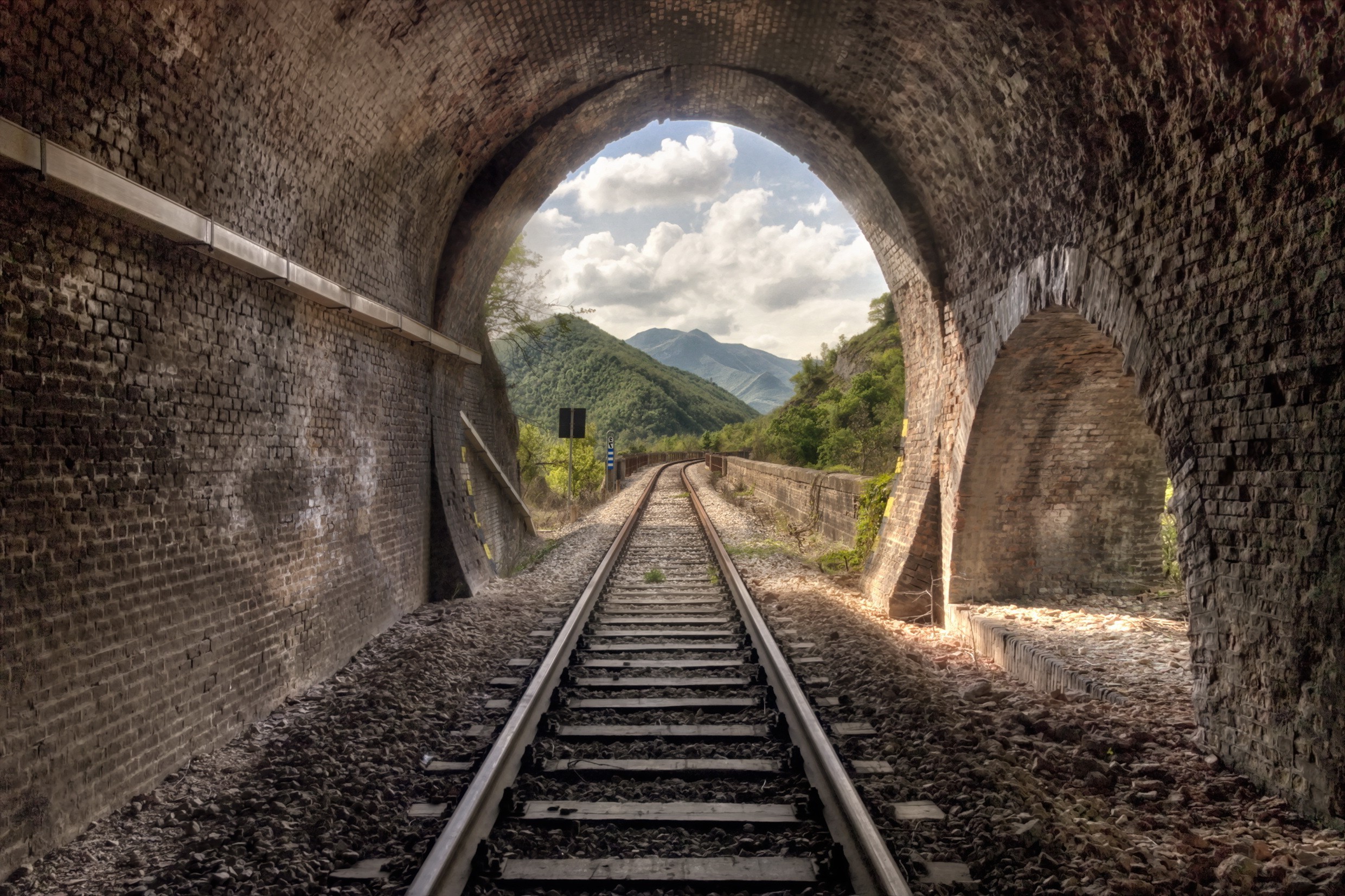 Railway tunnel arch with mountains and clouds HD Wallpaper