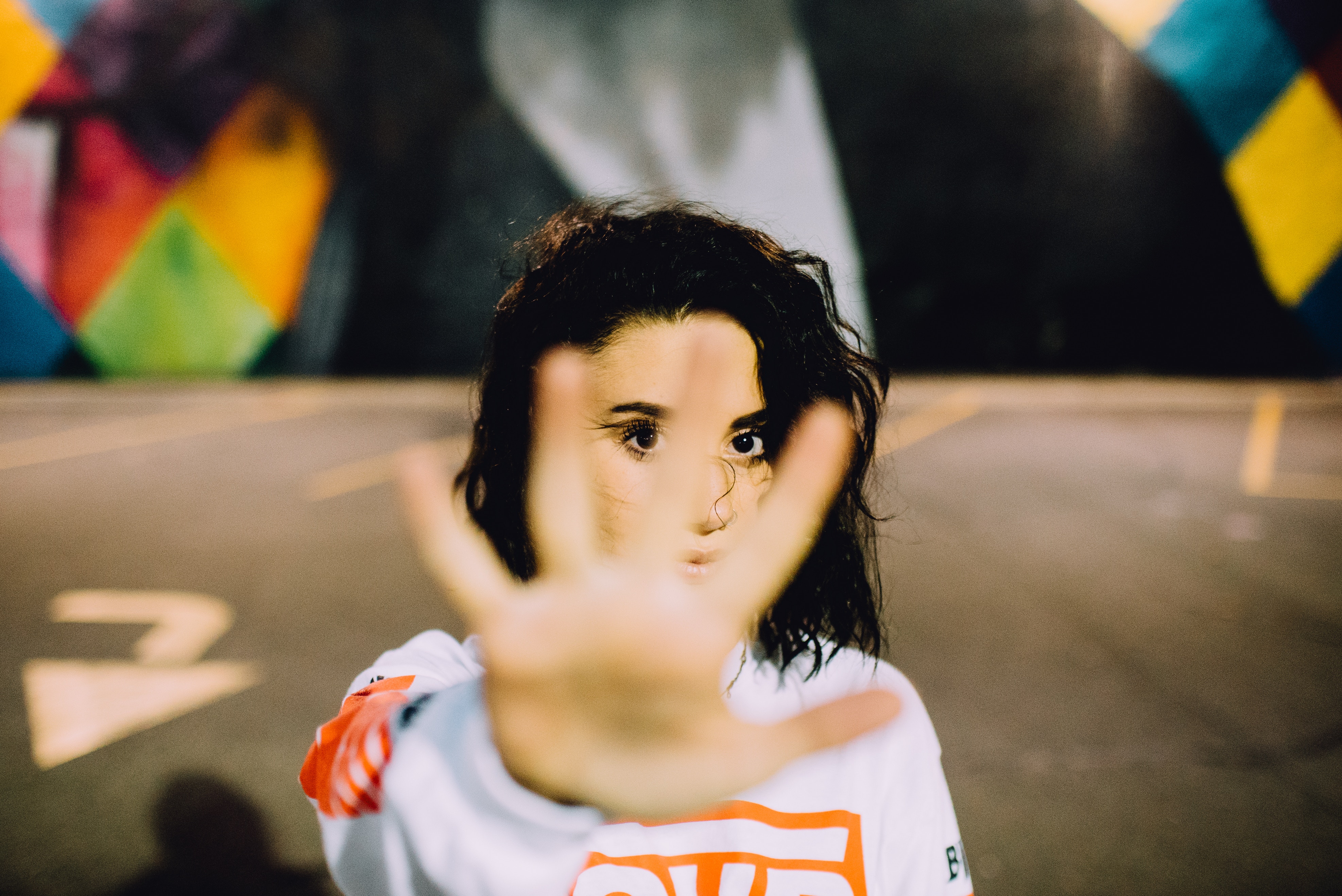Woman with hand up in front of face HD Wallpaper