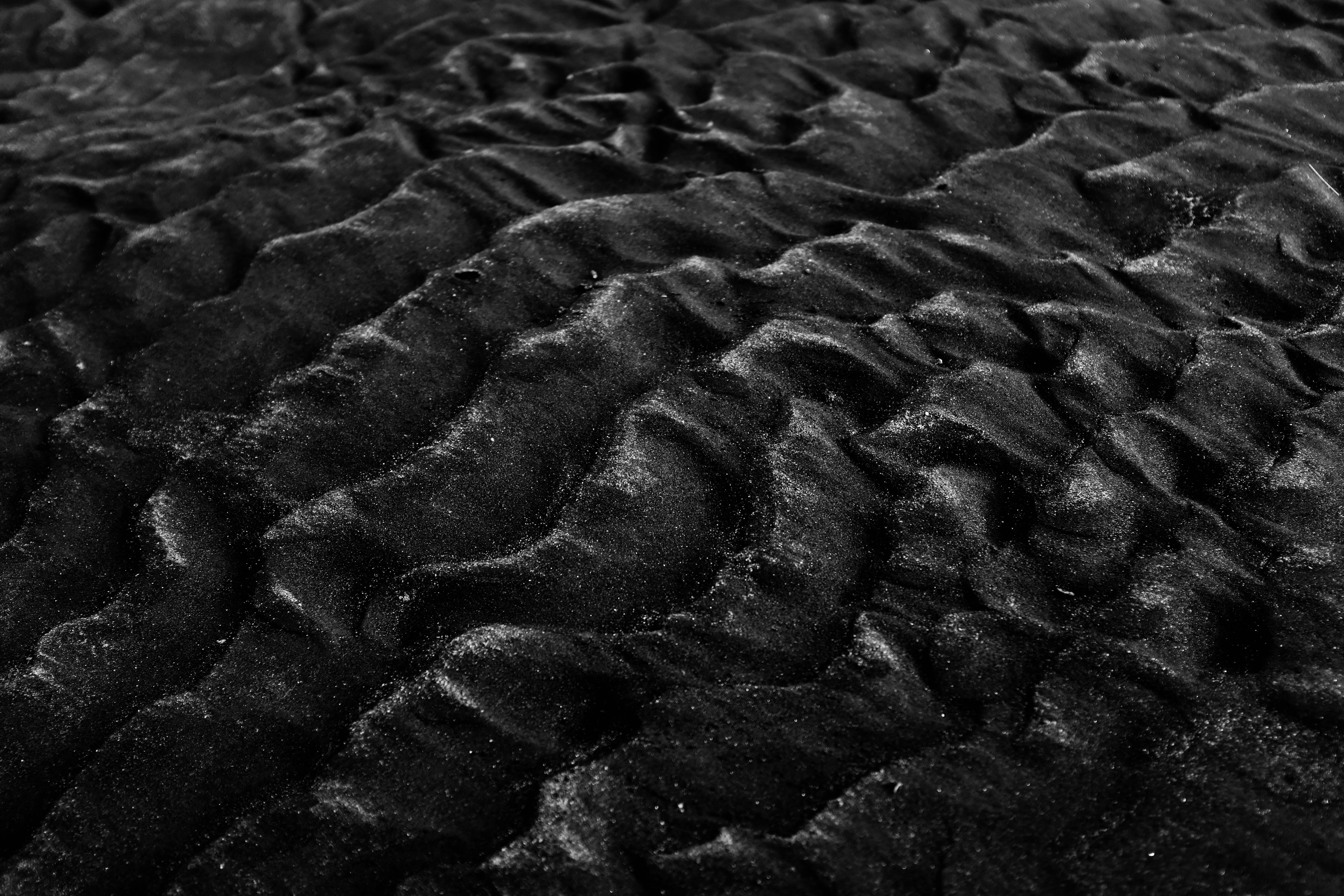 Black sand ripples on a beach HD Wallpaper