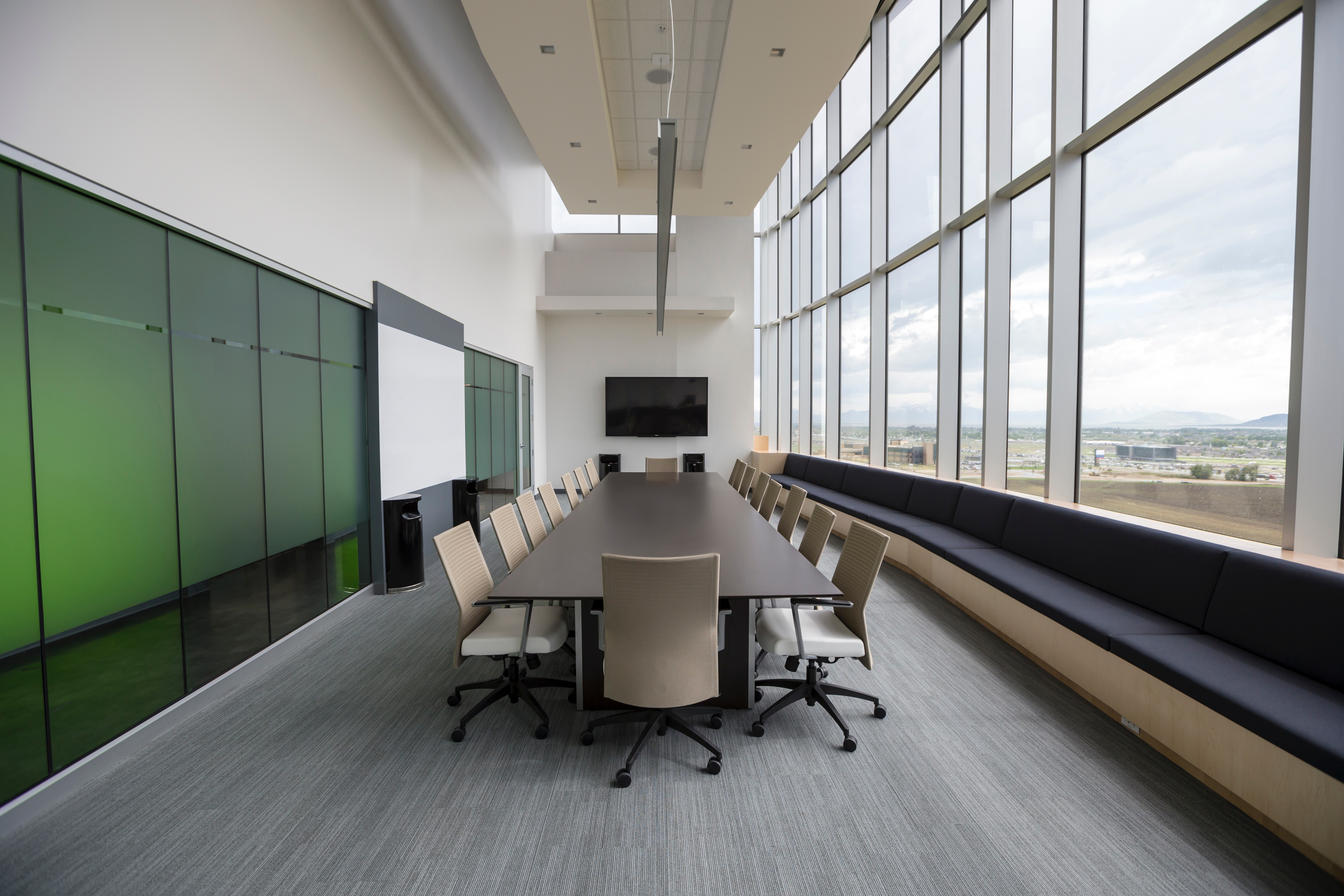 Modern boardroom with large windows and city view HD Wallpaper