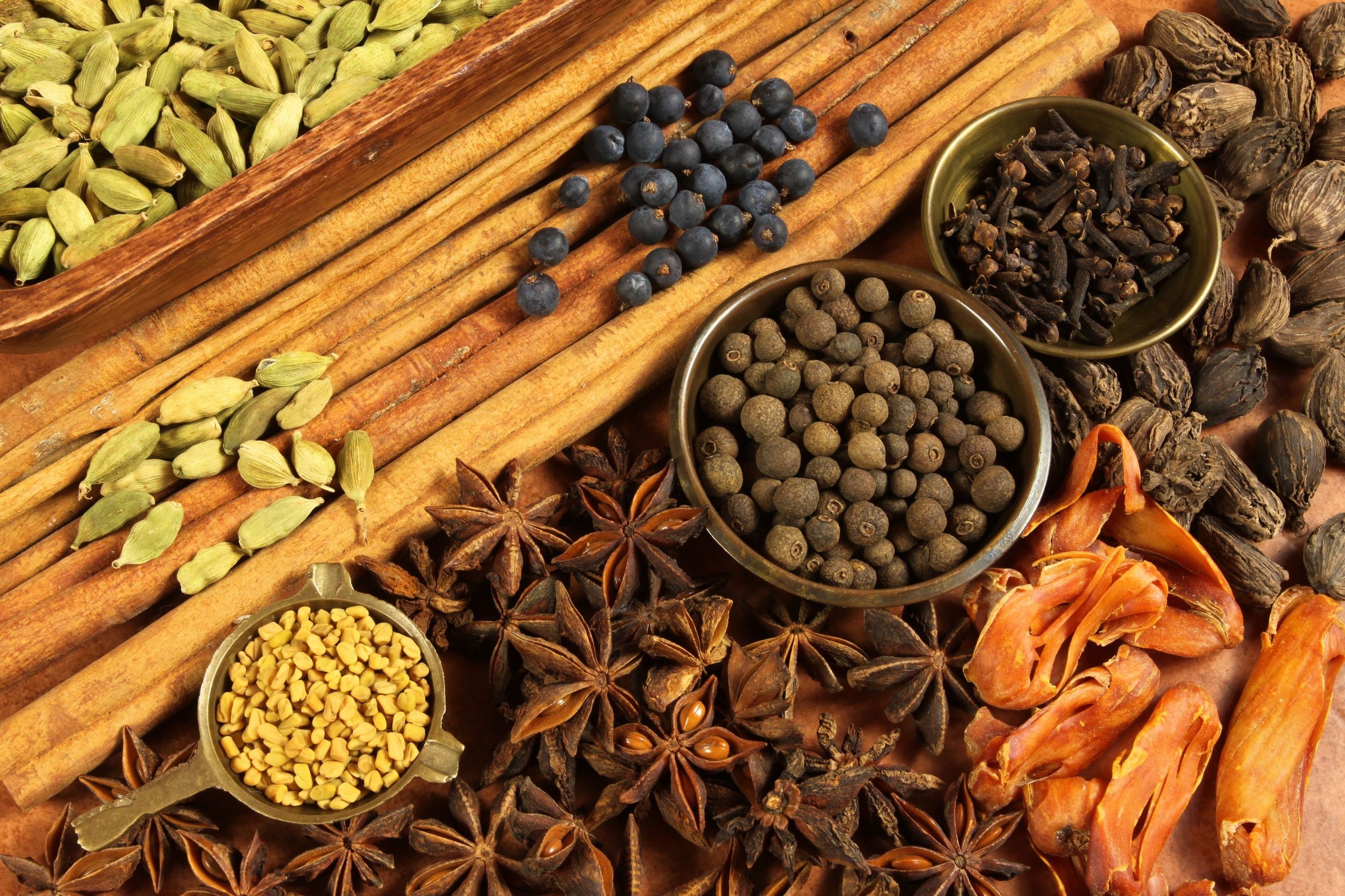 Assortment of spices including cinnamon, cardamom, and star anise HD Wallpaper