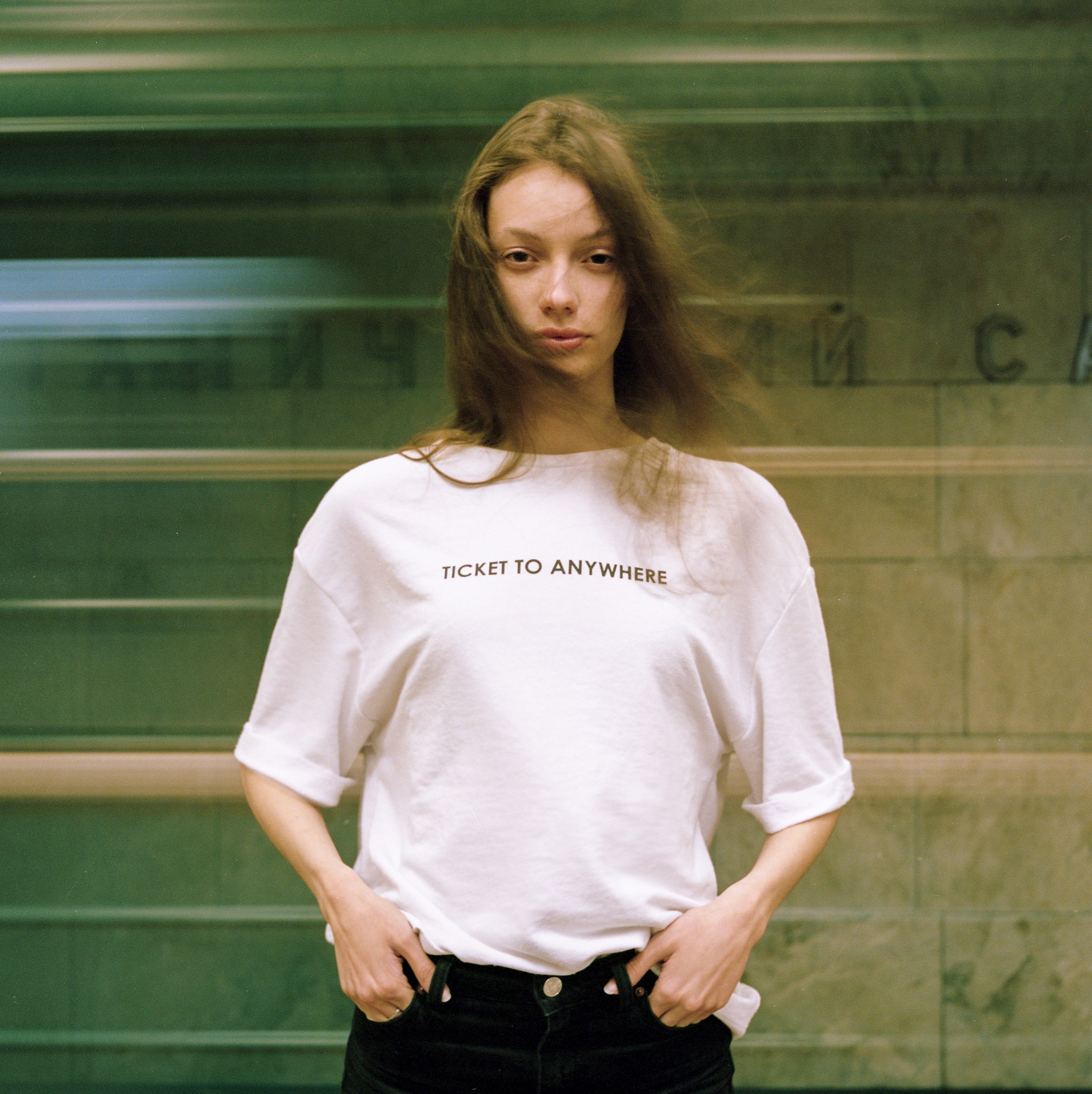 Young woman in a t-shirt in a subway HD Wallpaper