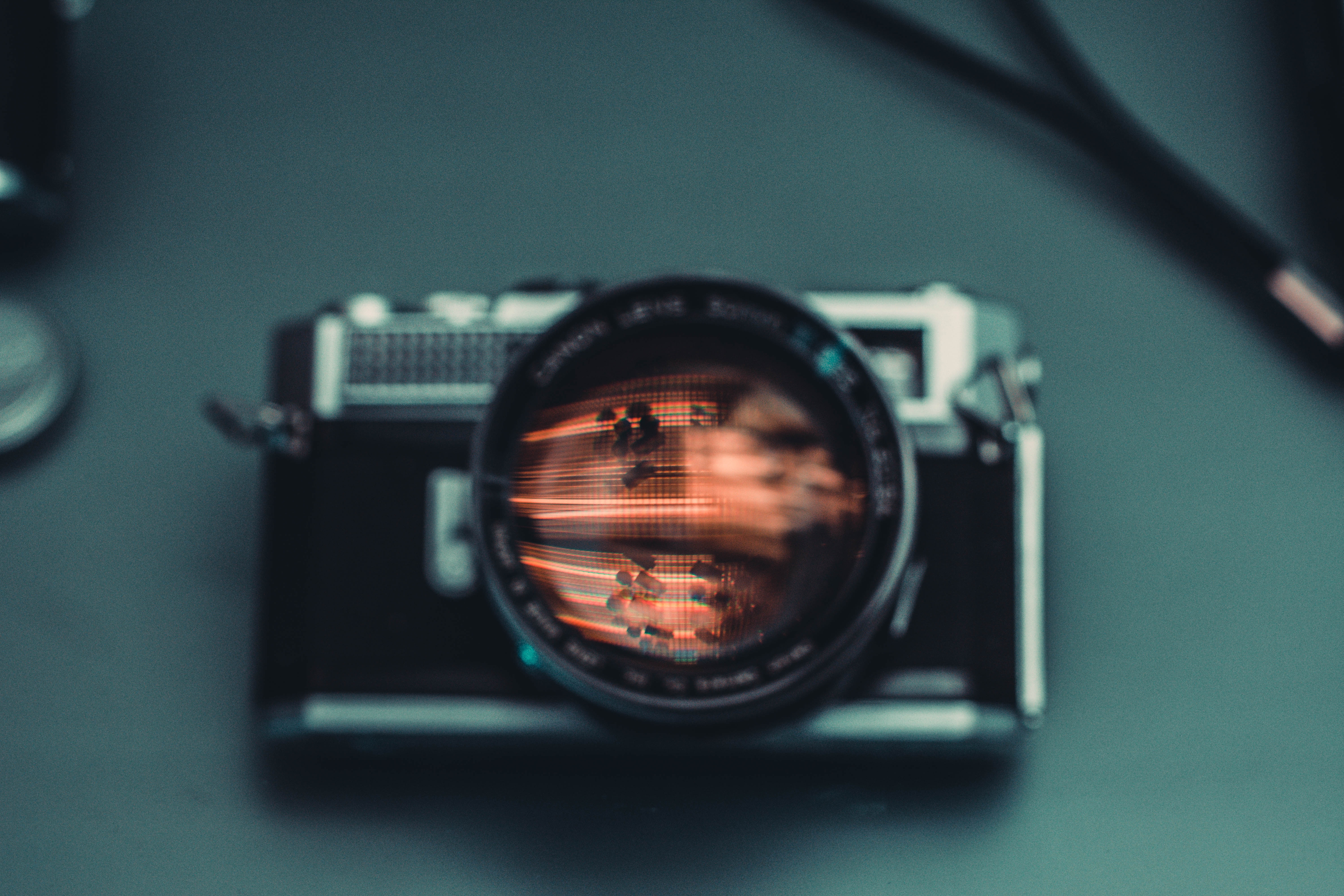 Vintage film camera with reflection in lens HD Wallpaper