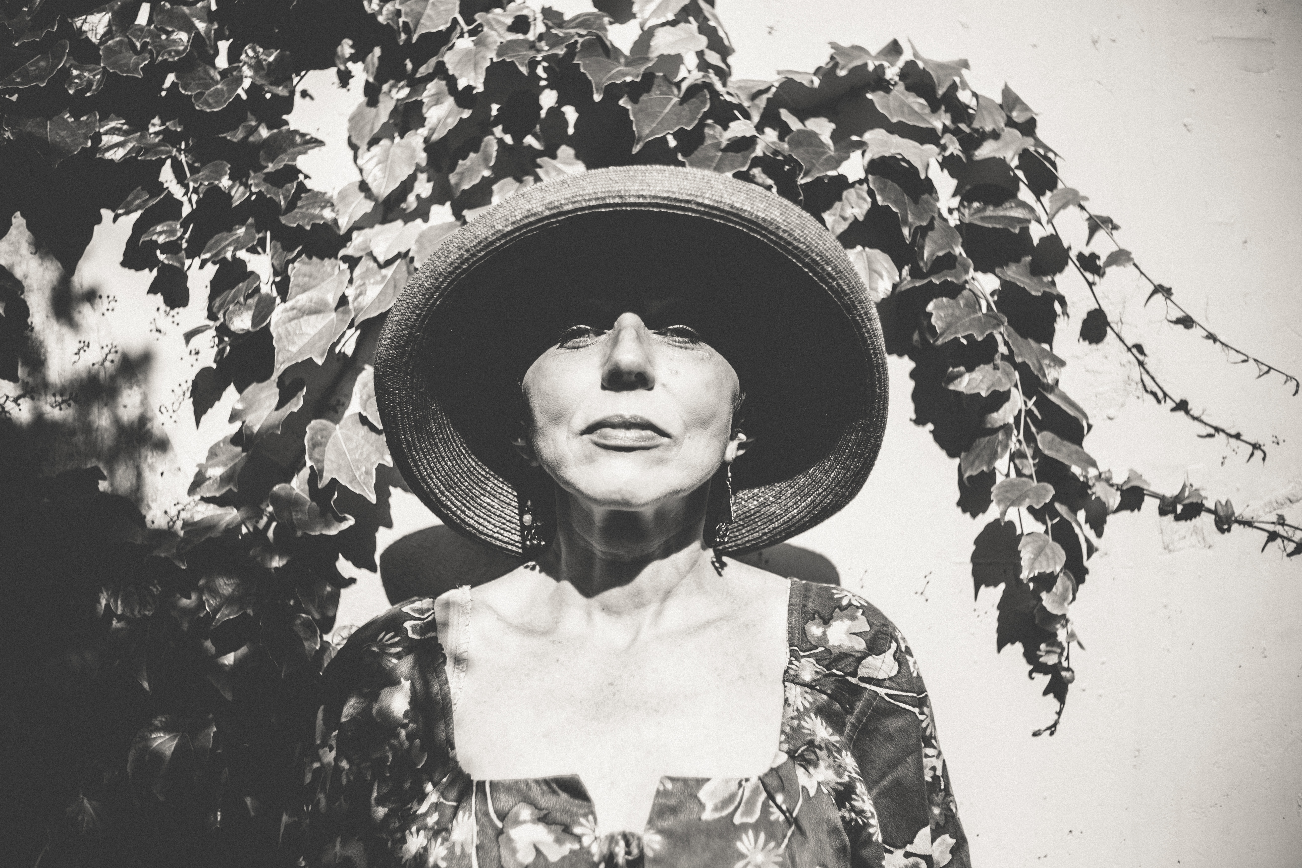 Elderly woman in a wide-brimmed hat and floral dress HD Wallpaper