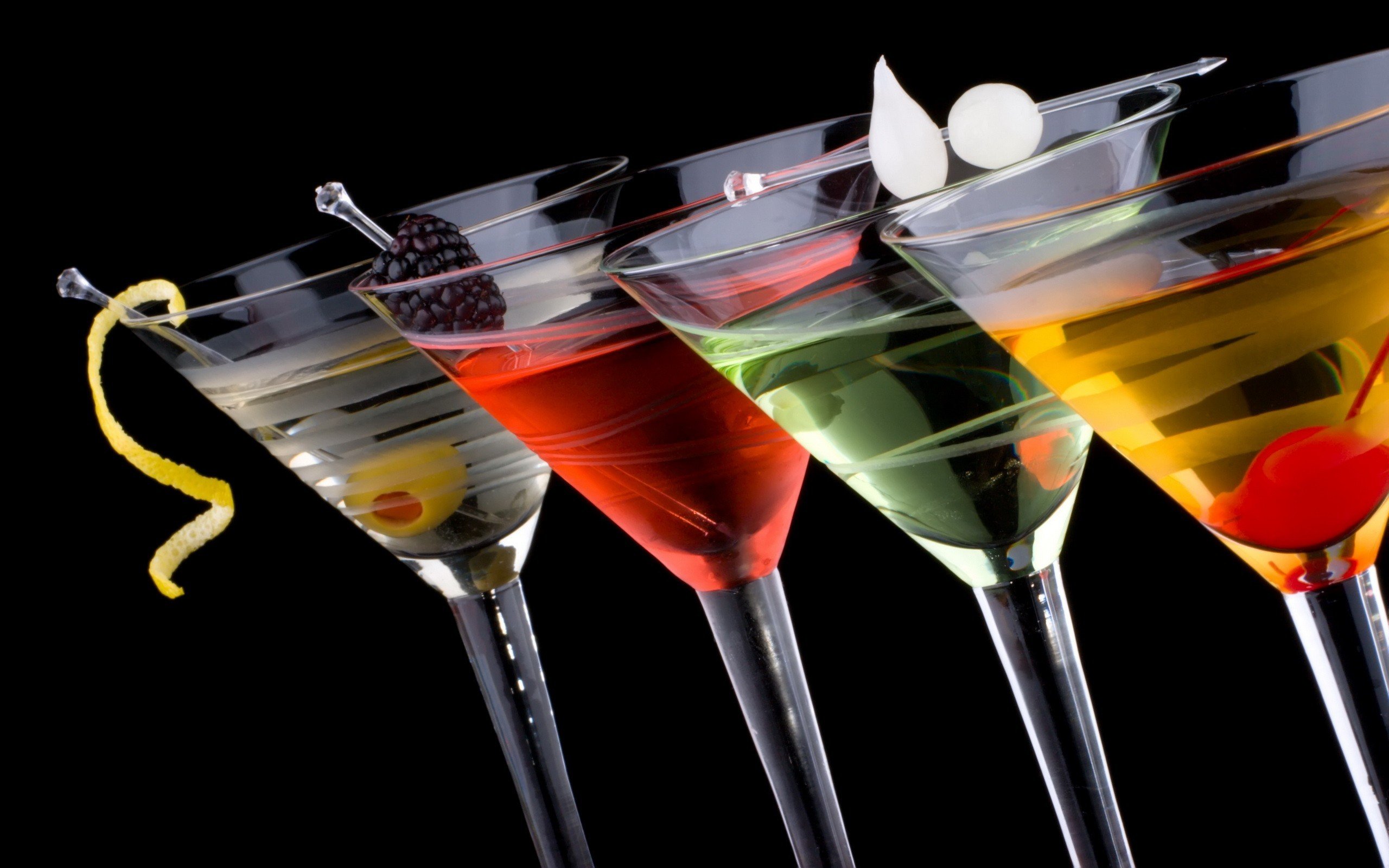 Four colorful cocktails with garnishes on black background HD Wallpaper