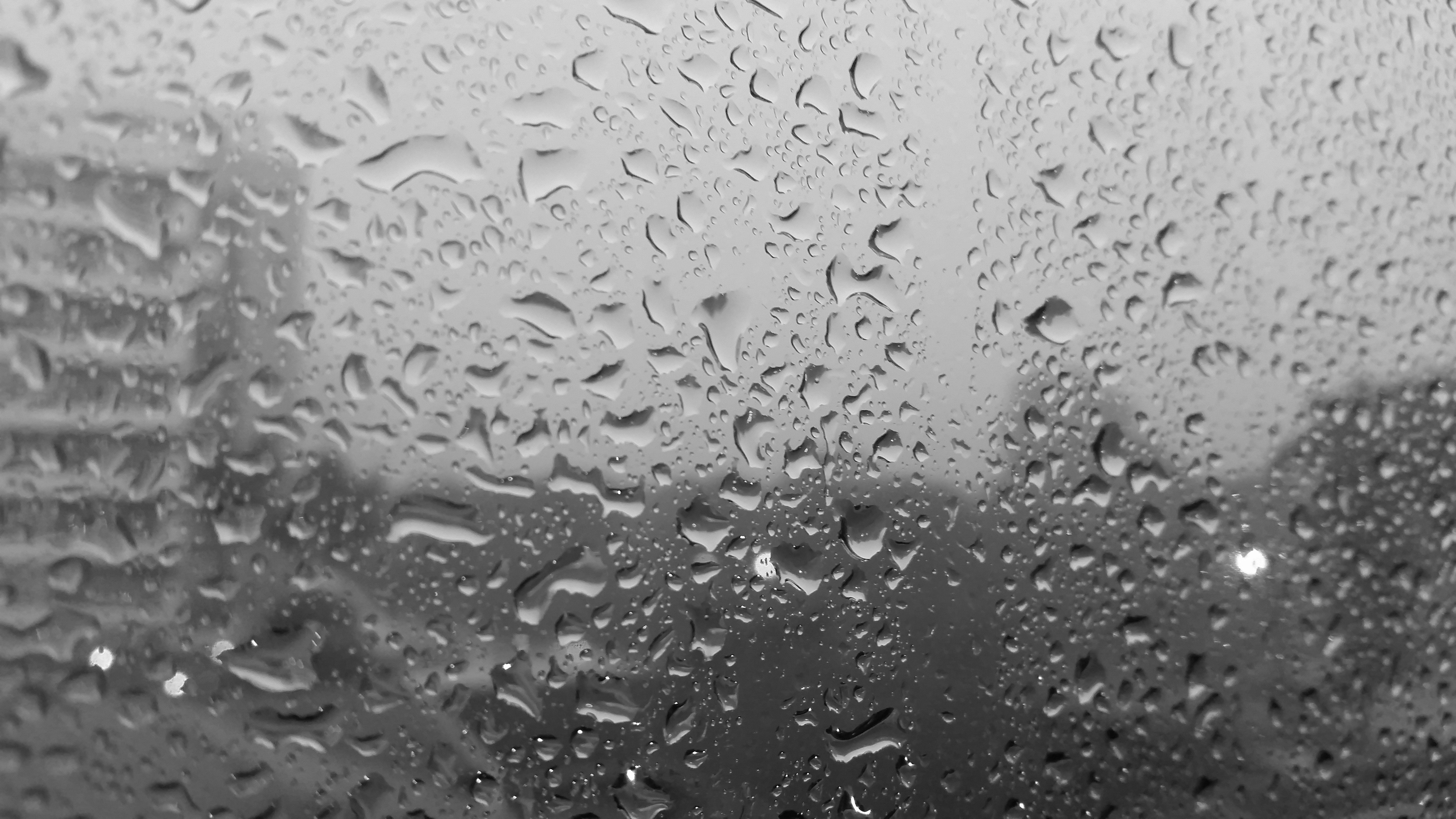 Raindrops on a window overlooking a city HD Wallpaper