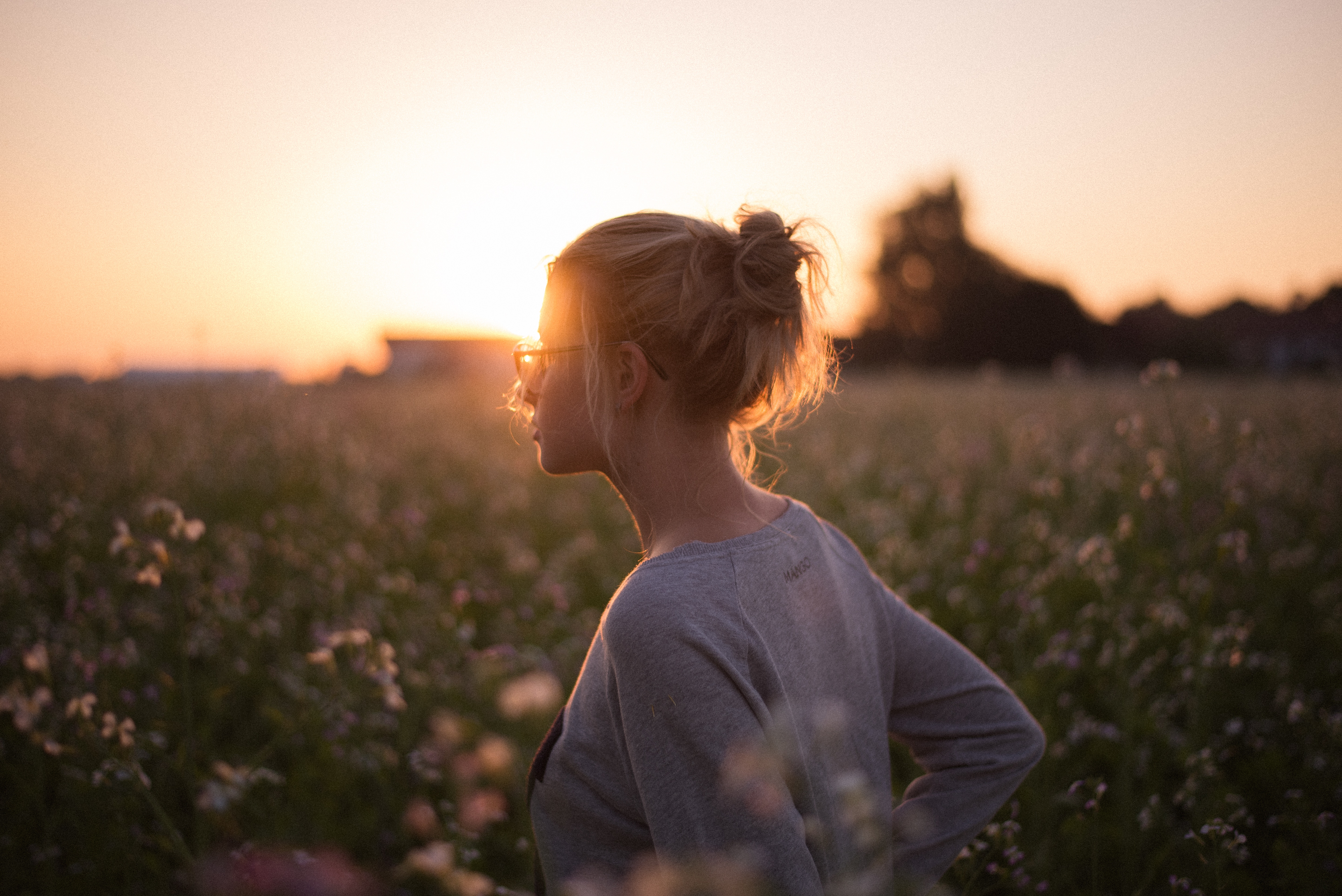 Woman in a field at sunset HD Wallpaper