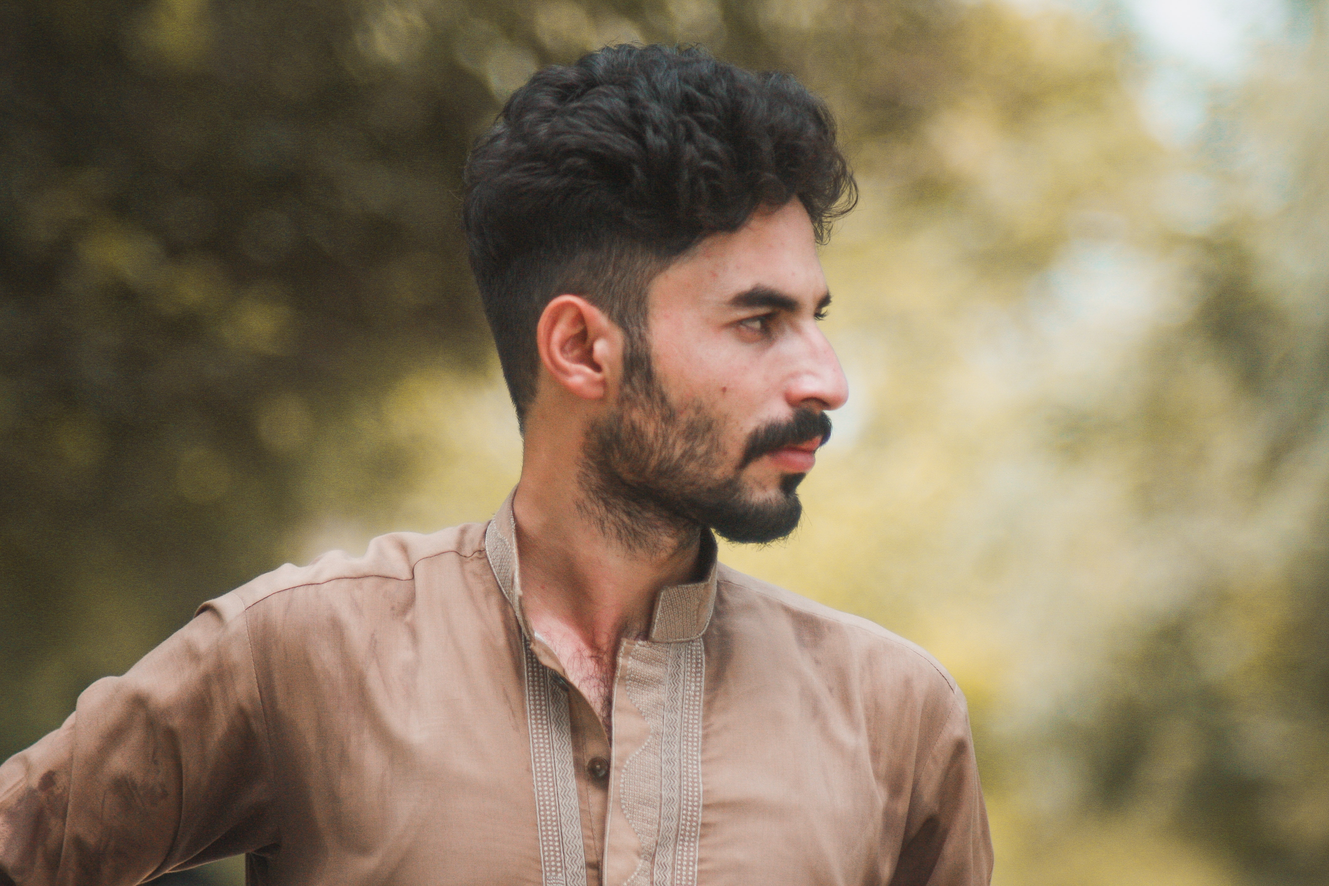 Man with beard in brown kurta outdoors HD Wallpaper