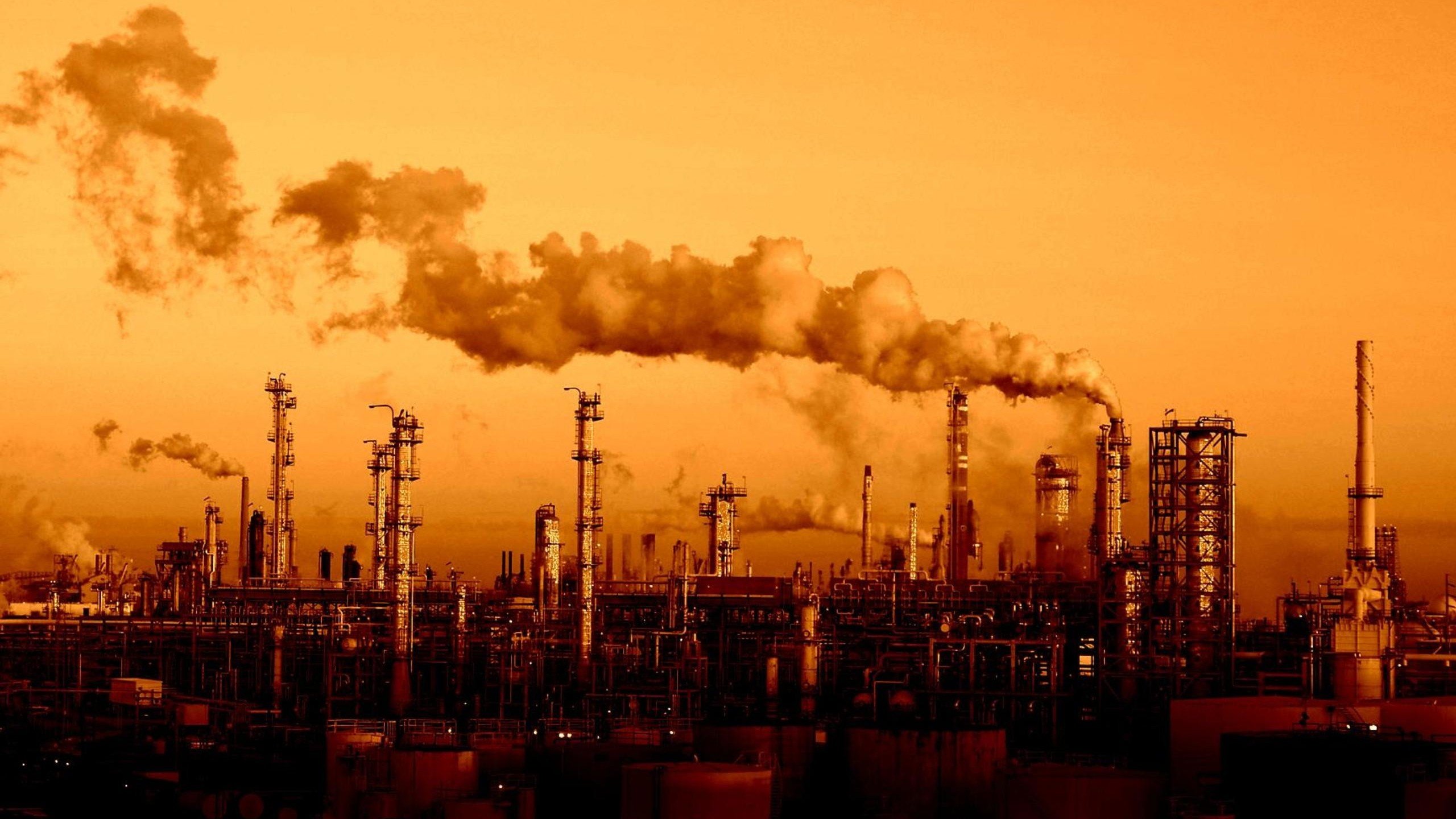 Industrial factory with smoke stacks at sunset HD Wallpaper