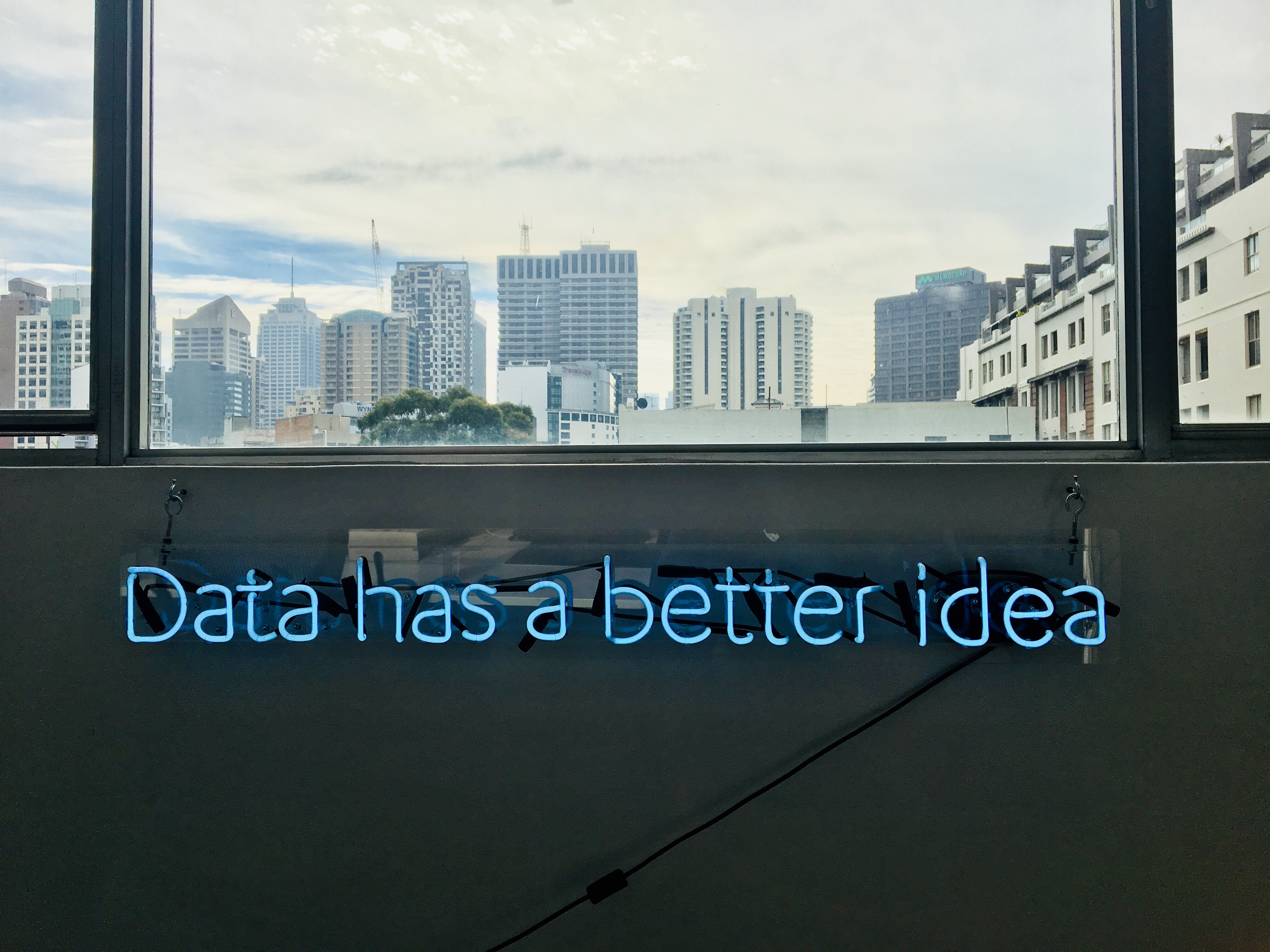 Blue neon sign "Data has a better idea" in an office HD Wallpaper