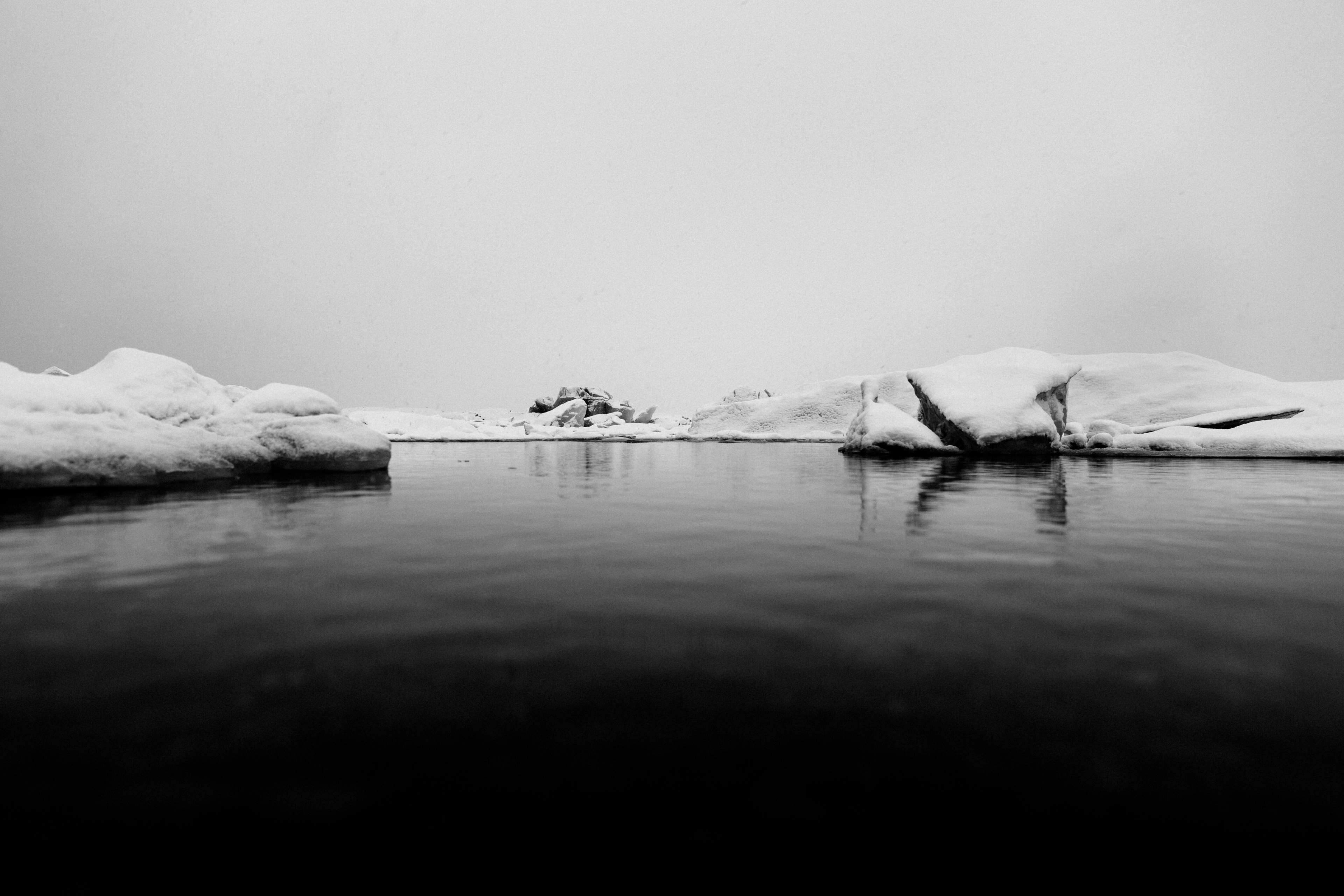 Black and white image of icebergs on a lake in Iceland 4K HD Wallpaper