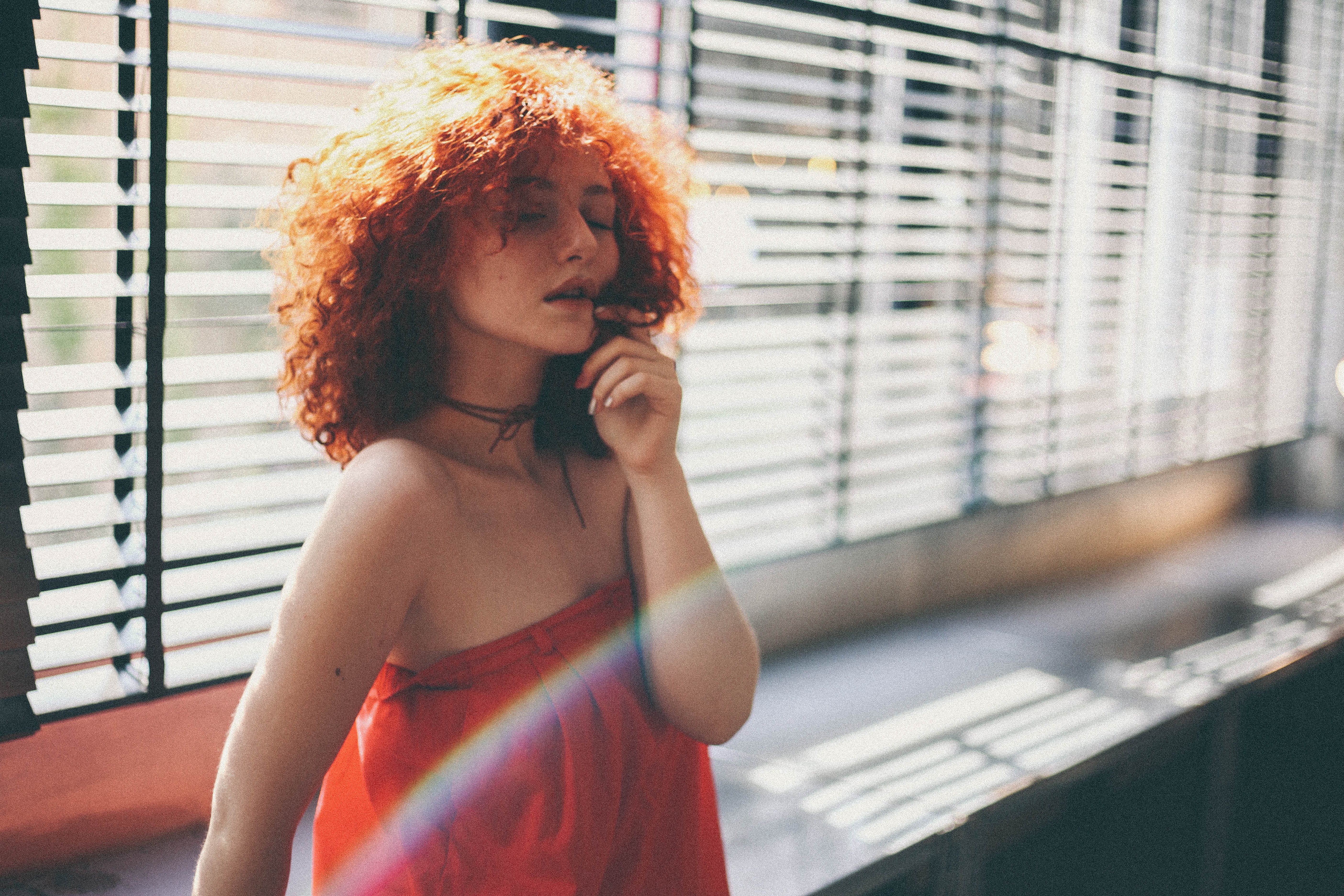 Woman with red hair and red dress near window HD Wallpaper