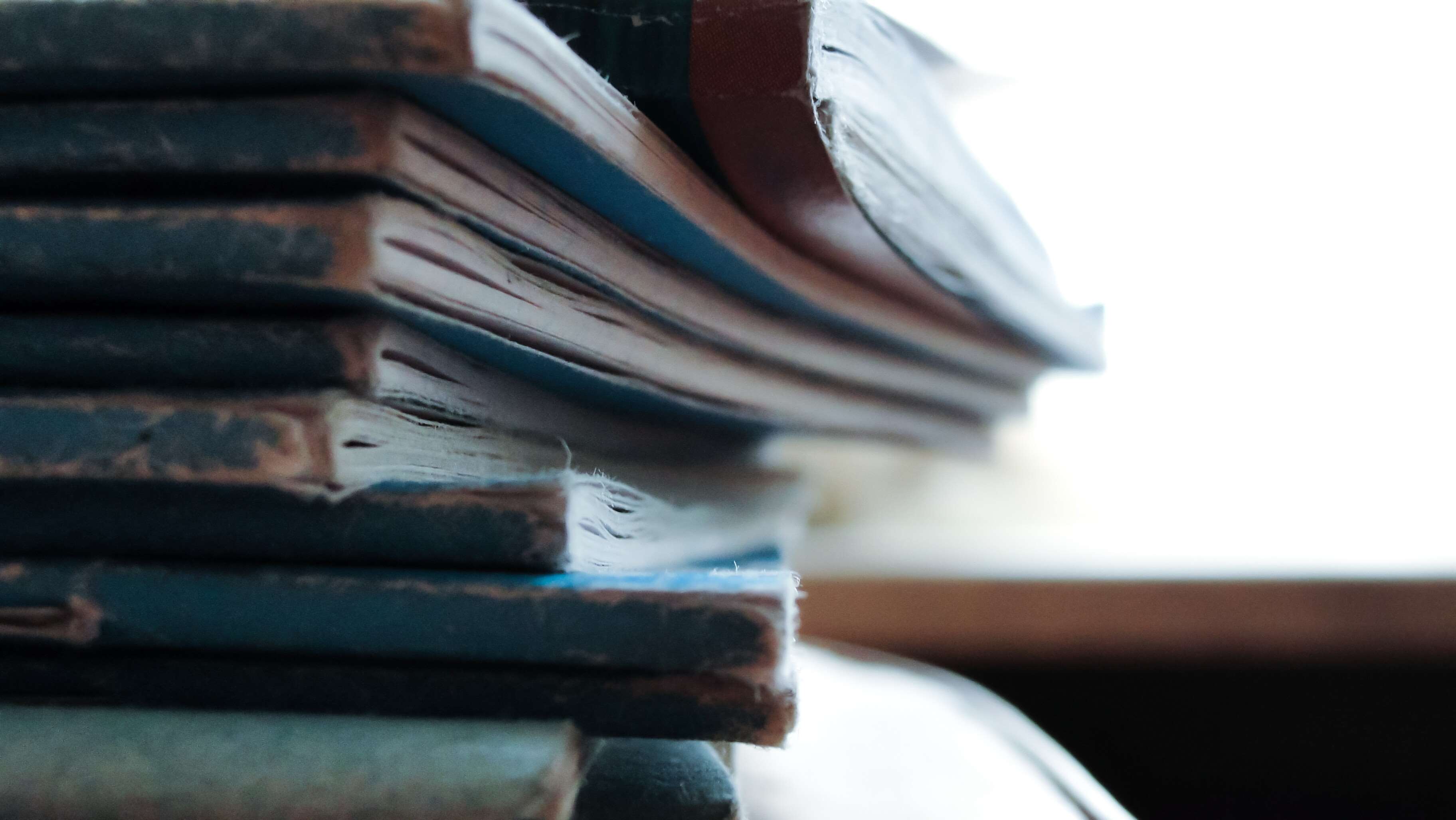 Stack of worn out books HD Wallpaper
