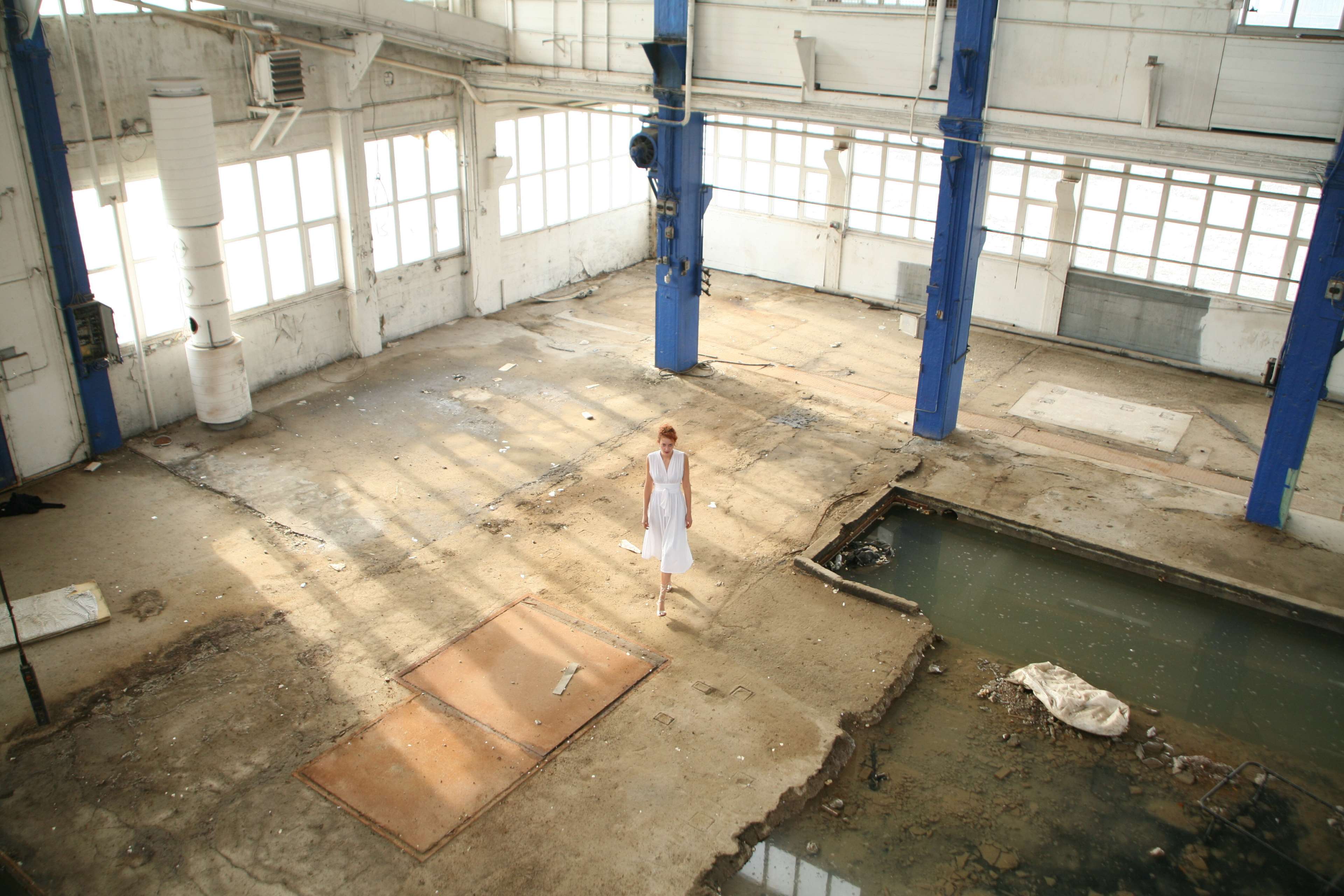 Woman in white dress in abandoned warehouse with water HD Wallpaper