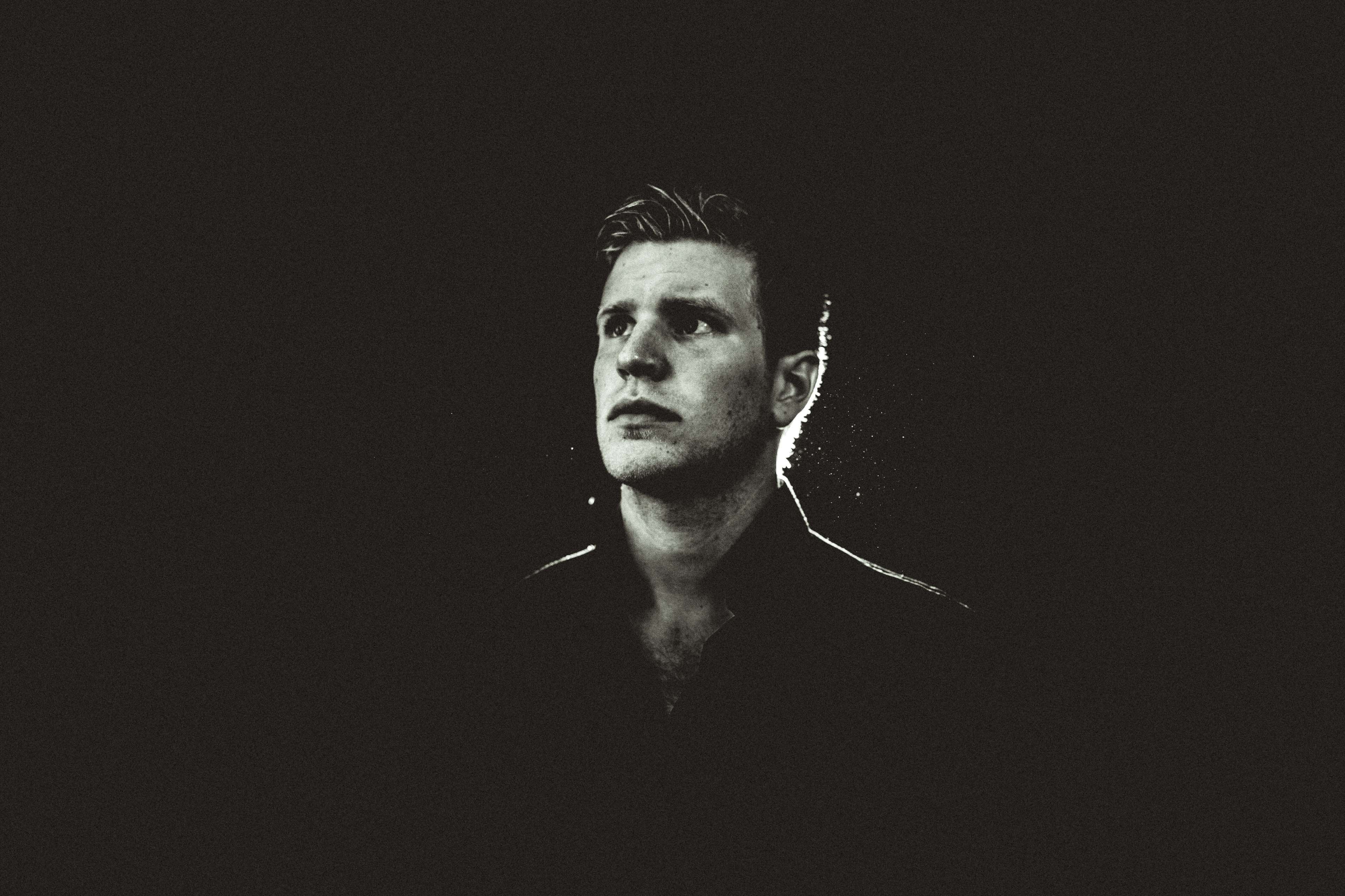 Man looking up in black and white portrait 4K HD Wallpaper
