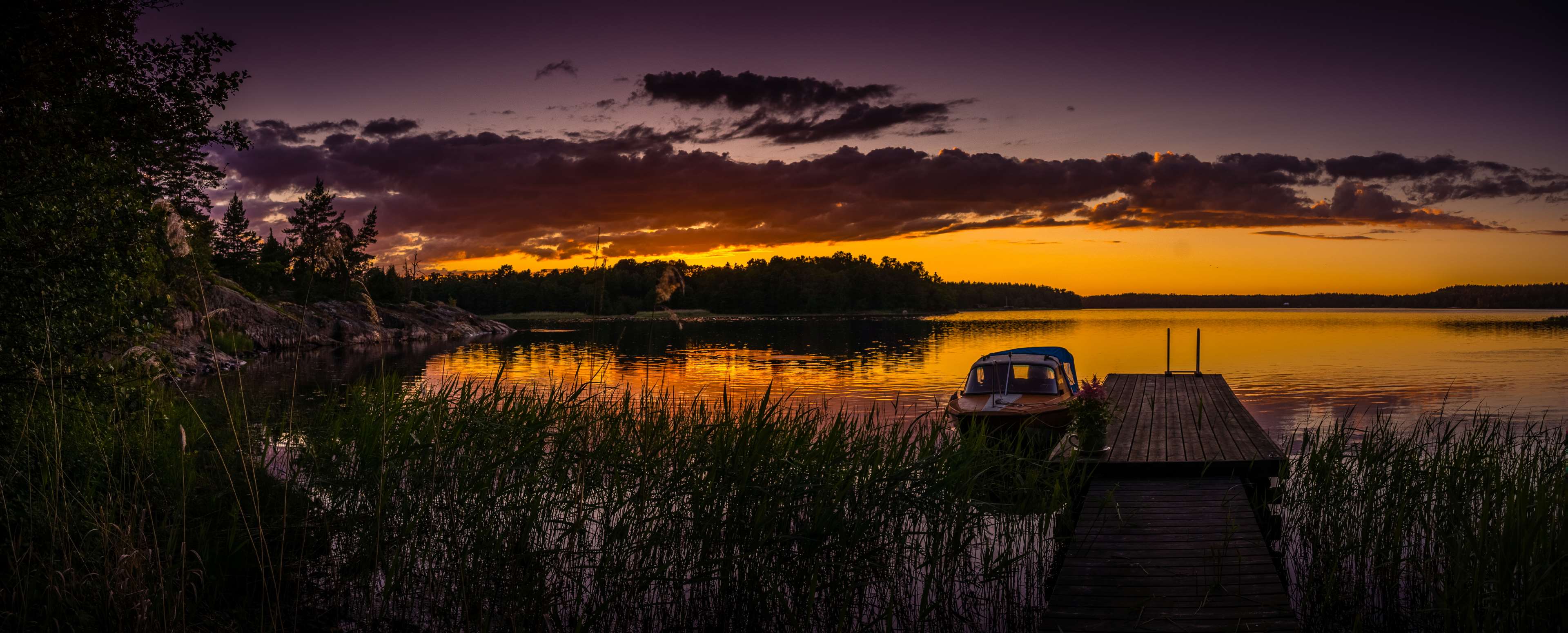 Boat docked at sunset on the Baltic Sea in Sweden HD Wallpaper
