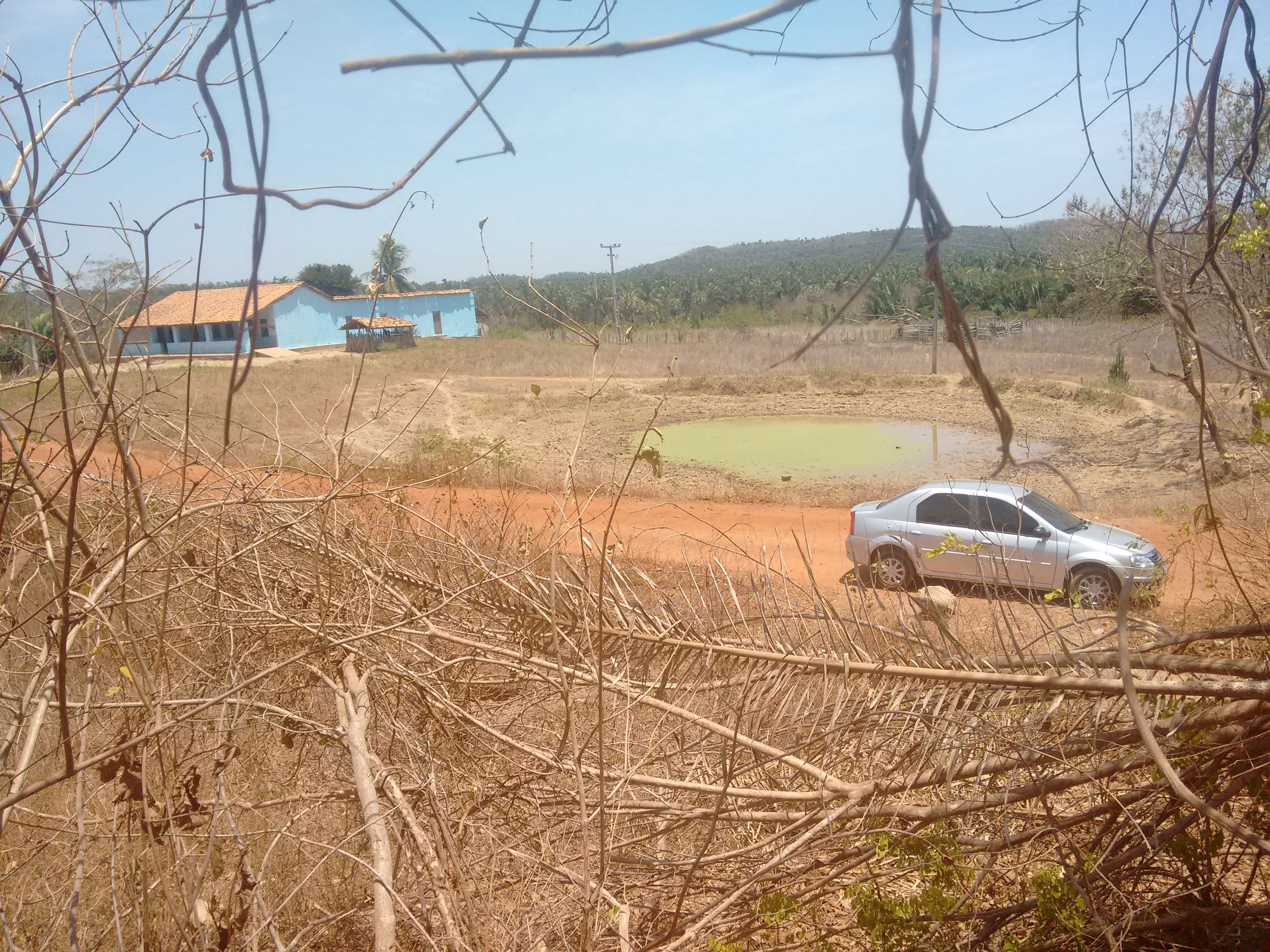 Rural landscape in Piaui, Brazil with a car and buildings HD Wallpaper