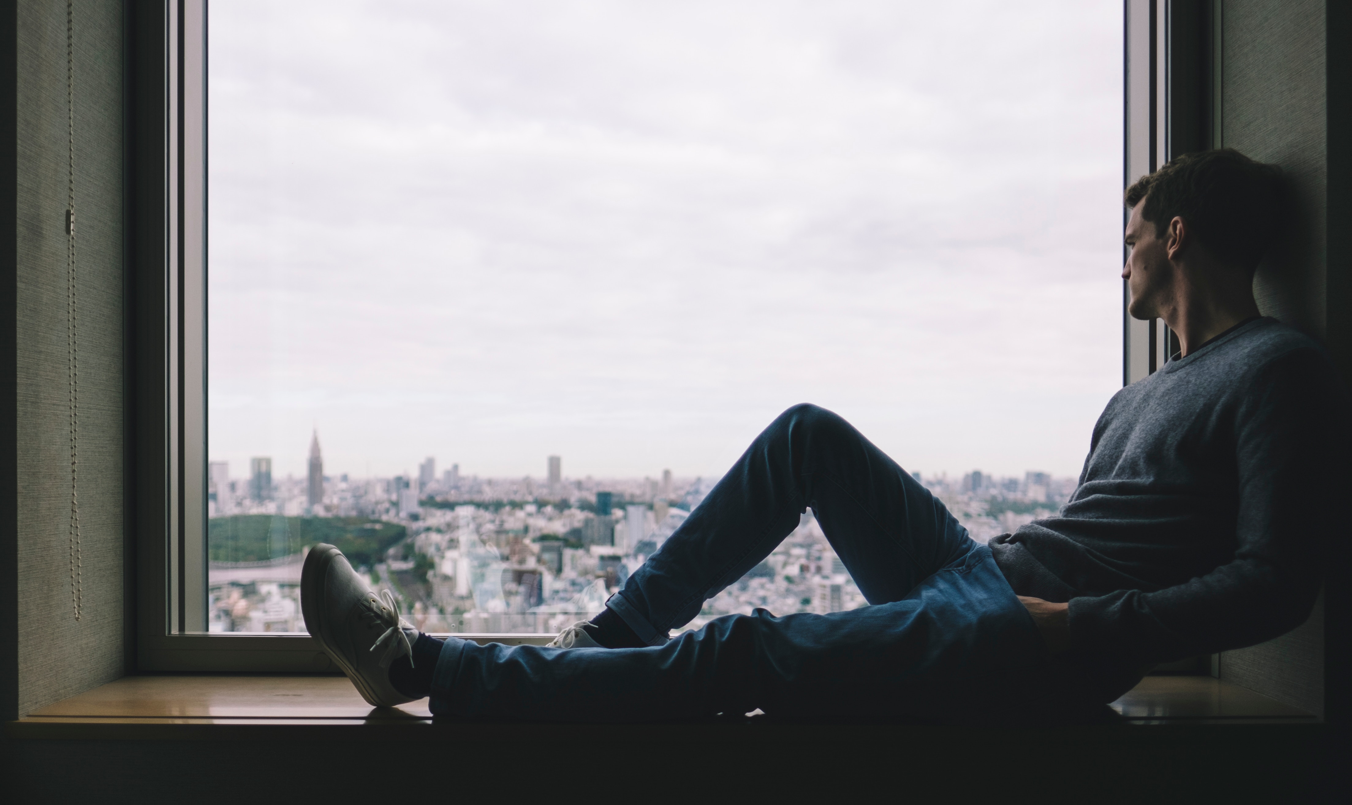 Man sitting on window sill overlooking Tokyo, Japan HD Wallpaper