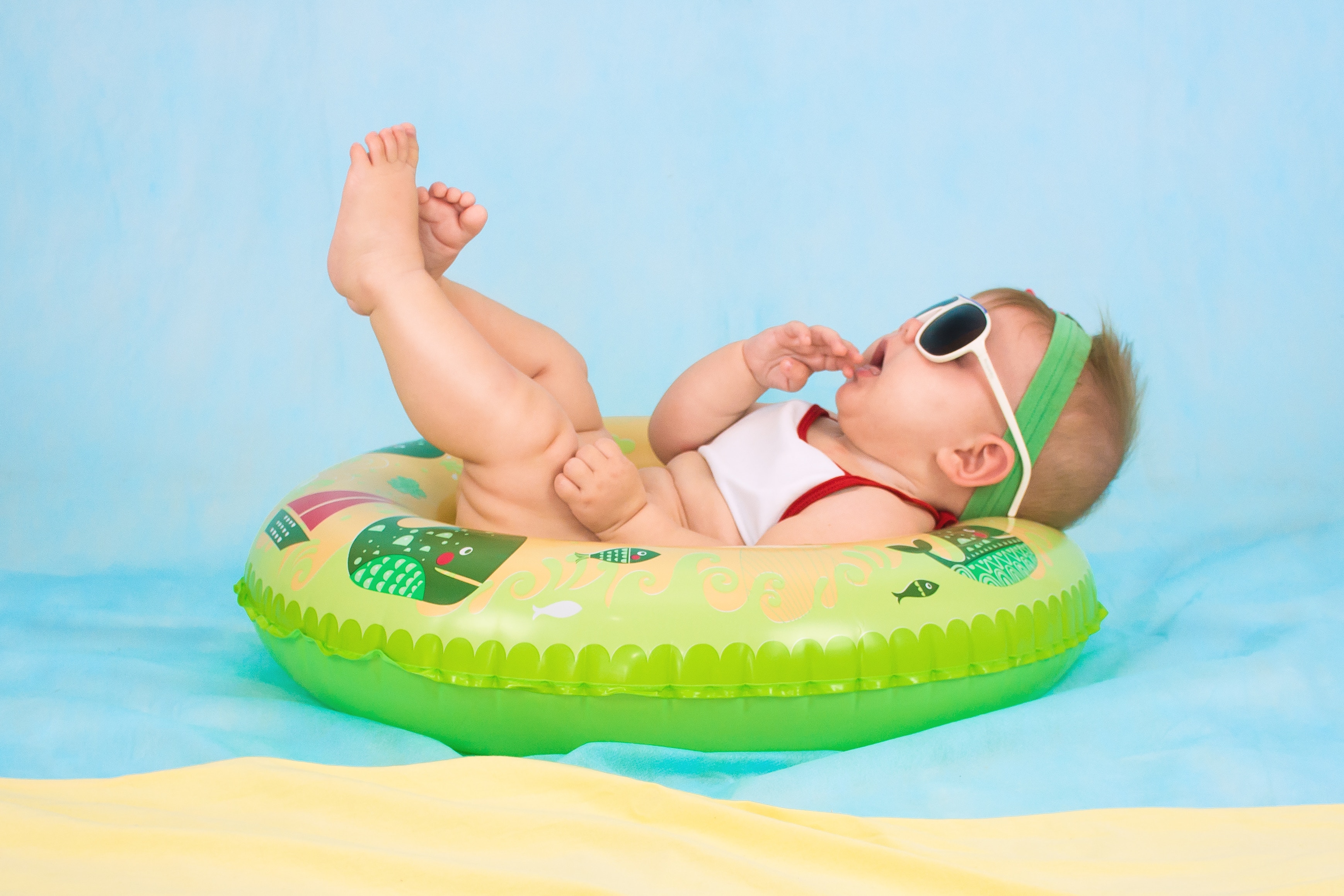 Baby in a float with sunglasses HD Wallpaper