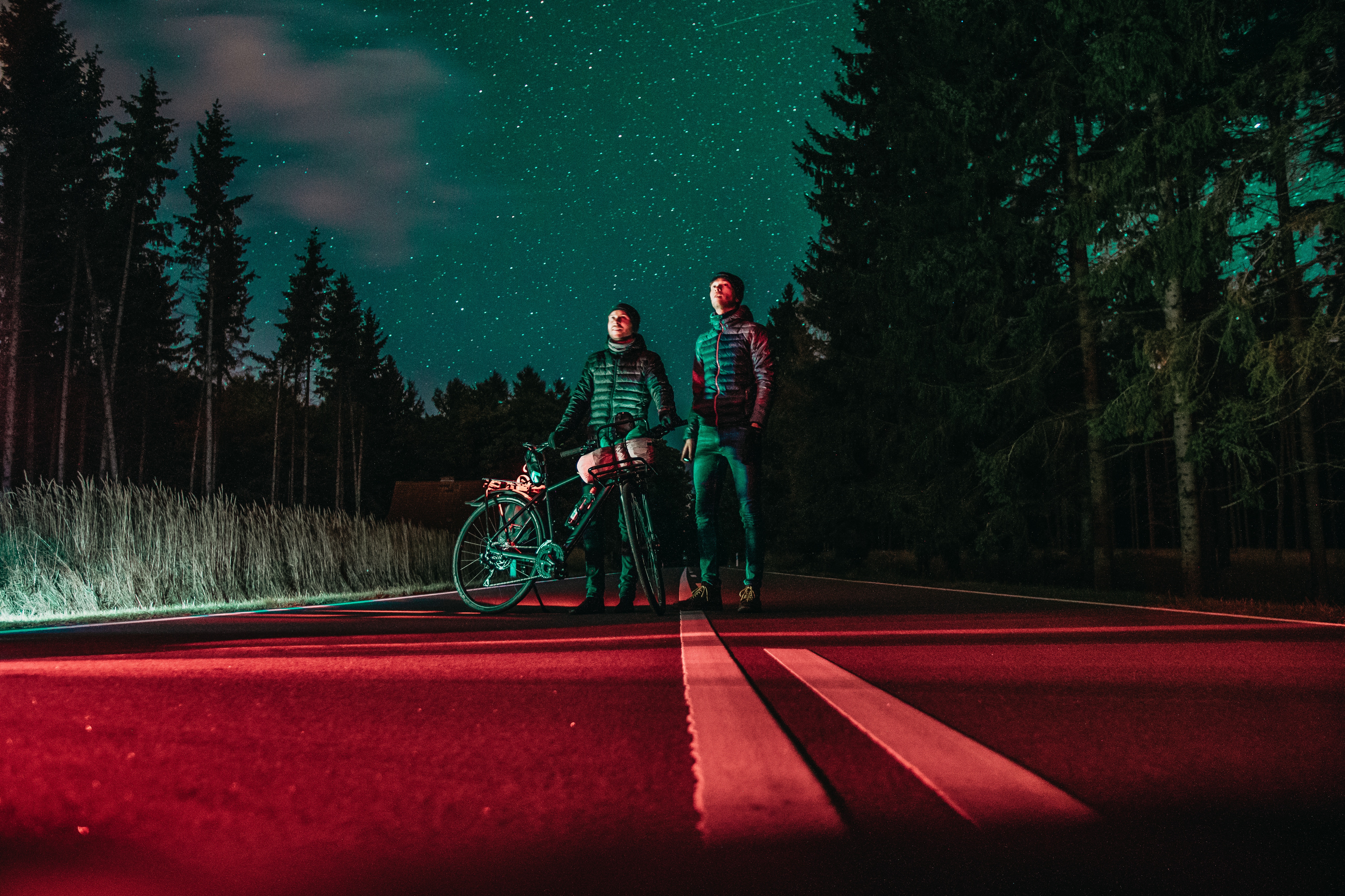 Two men and a bicycle under the night sky HD Wallpaper